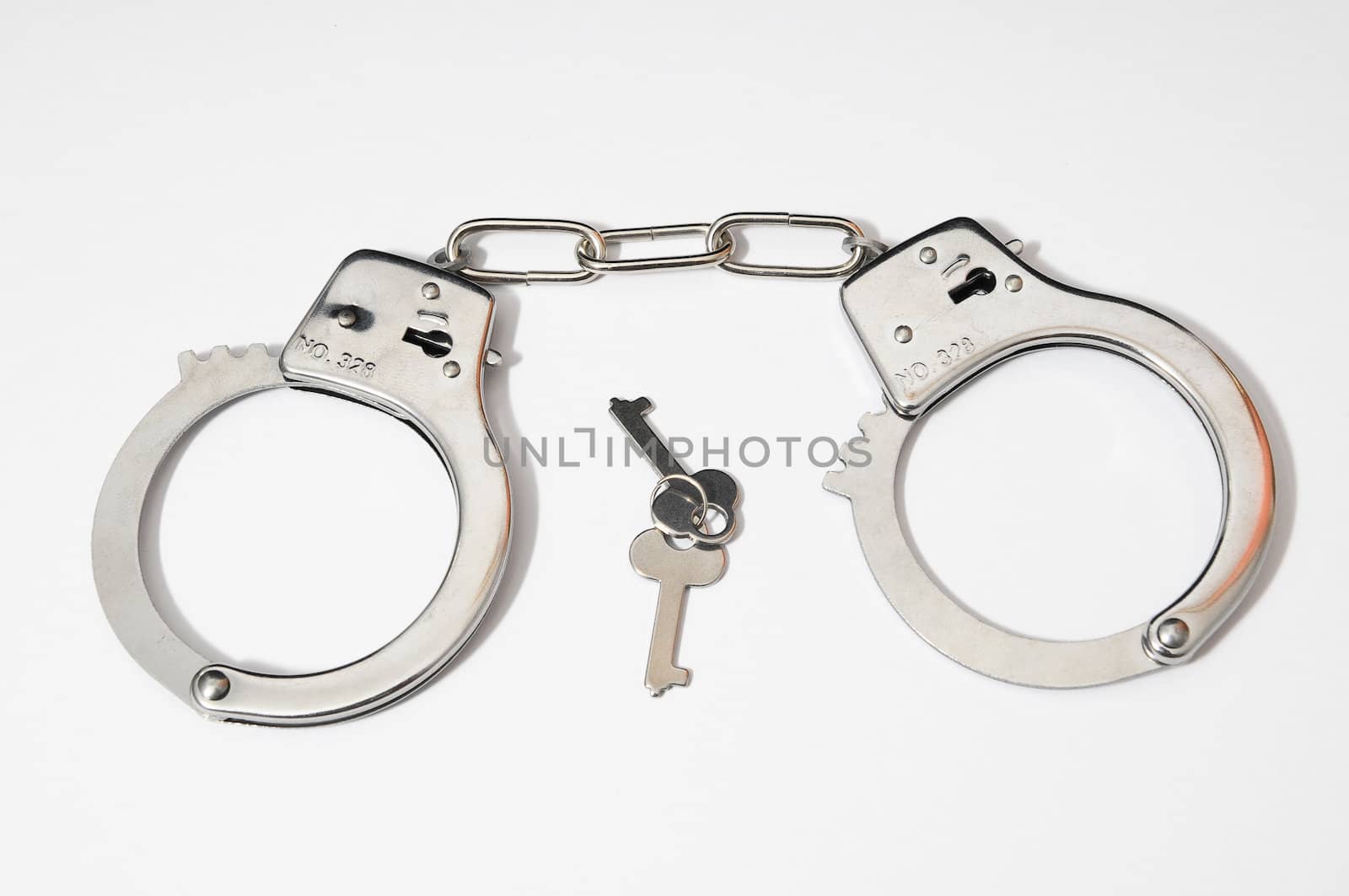 One Pair of Handcuffs on a Colored Background