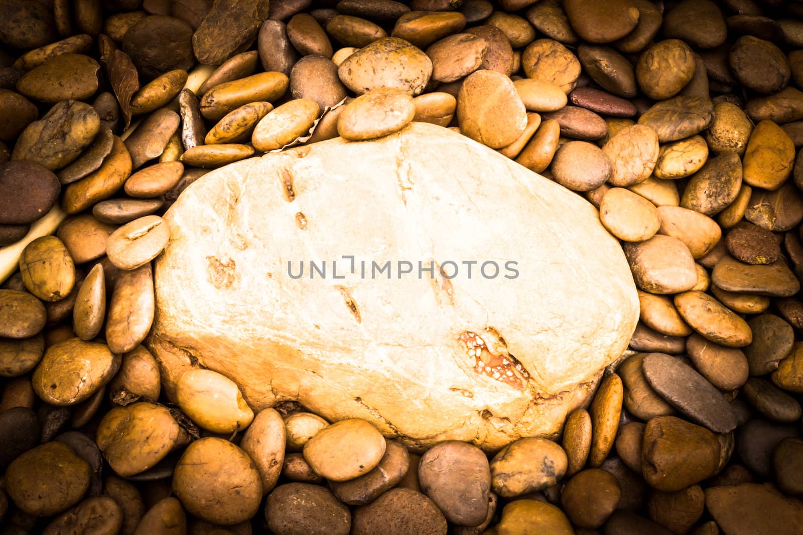 A big river stone on small river stone background by photo2life