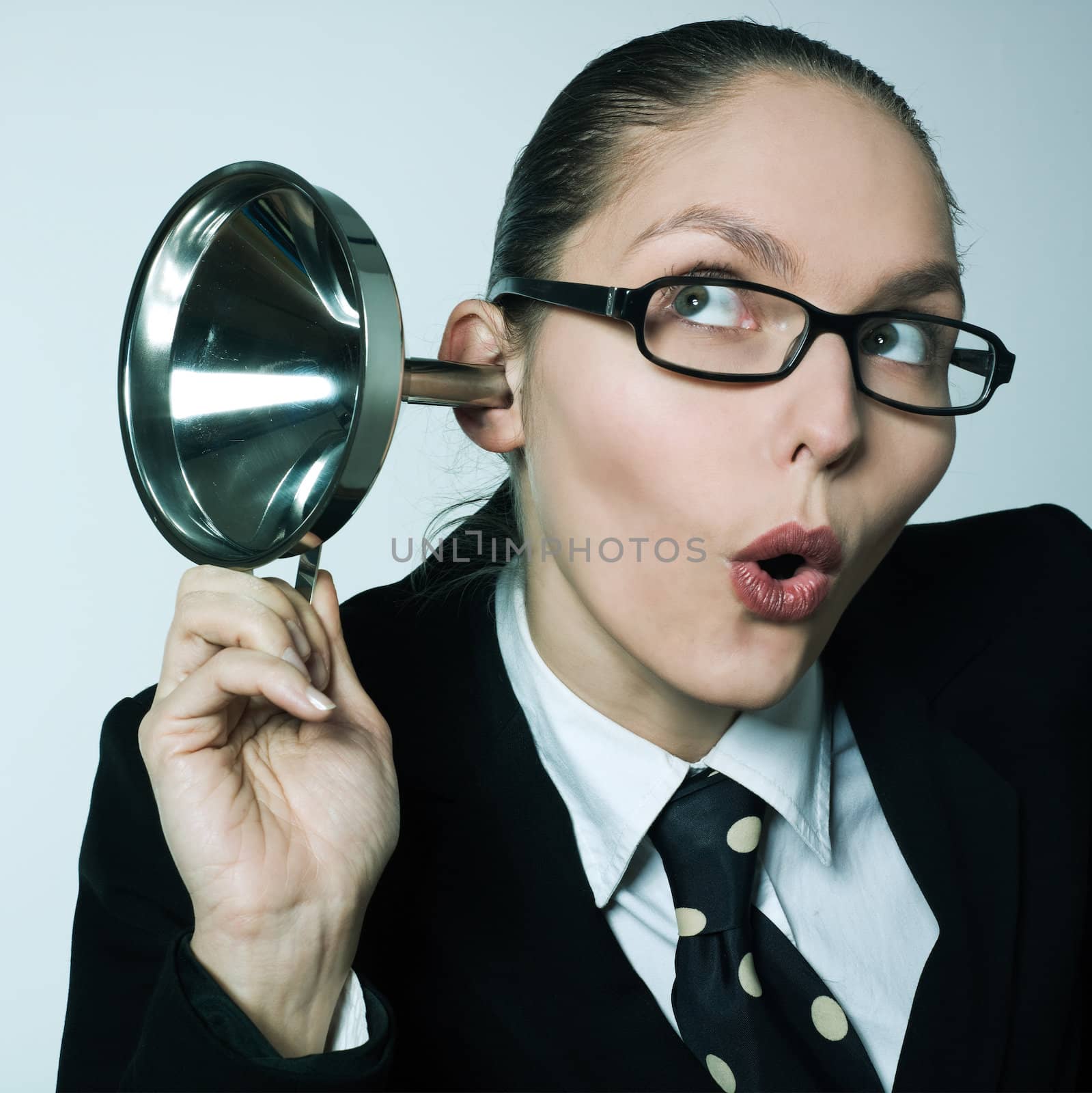 studio shot portrait of one caucasian curious business woman  hearing aid funnel curious spying gossip