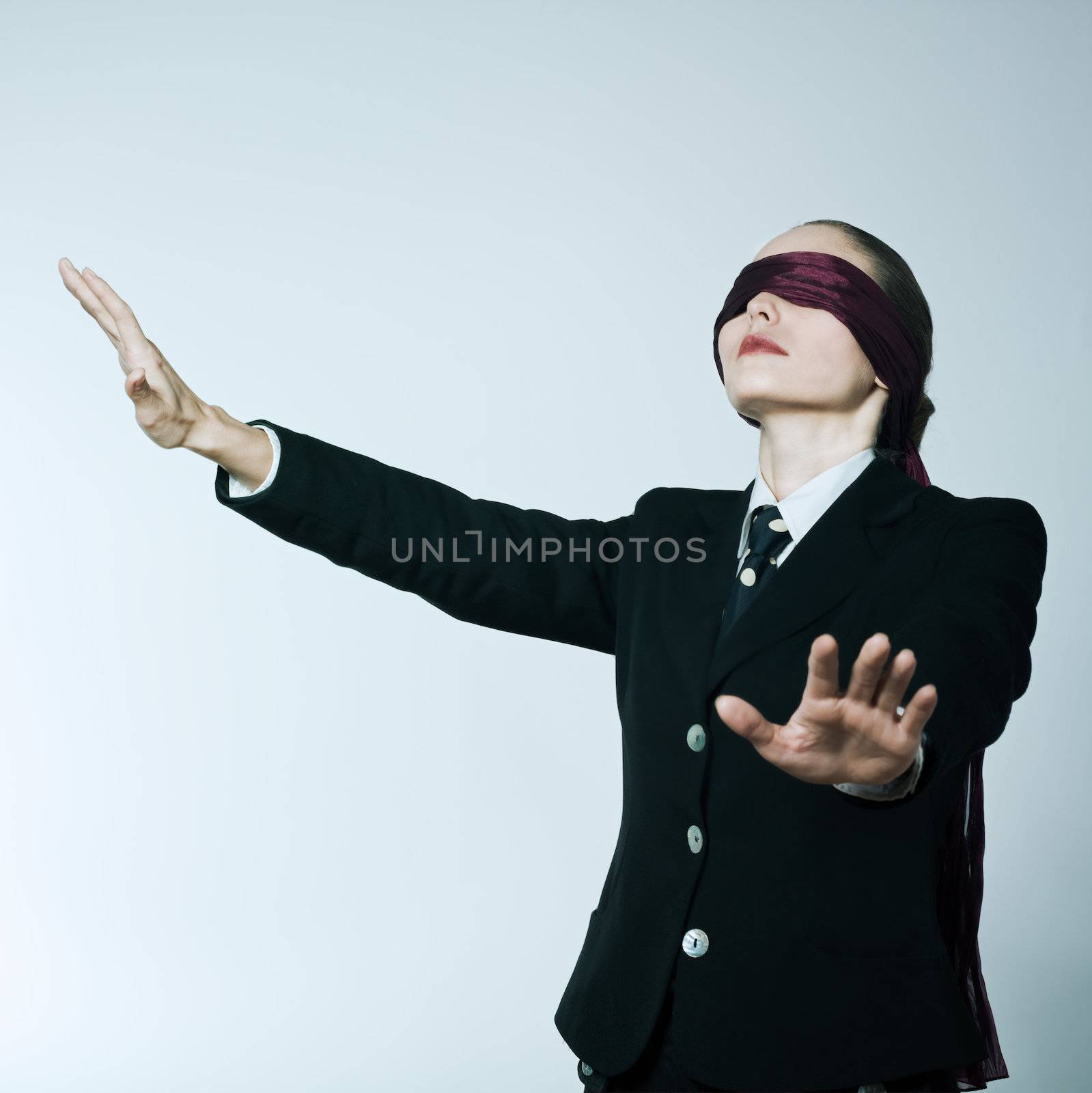 studio shot portrait of one caucasian young blindfold woman