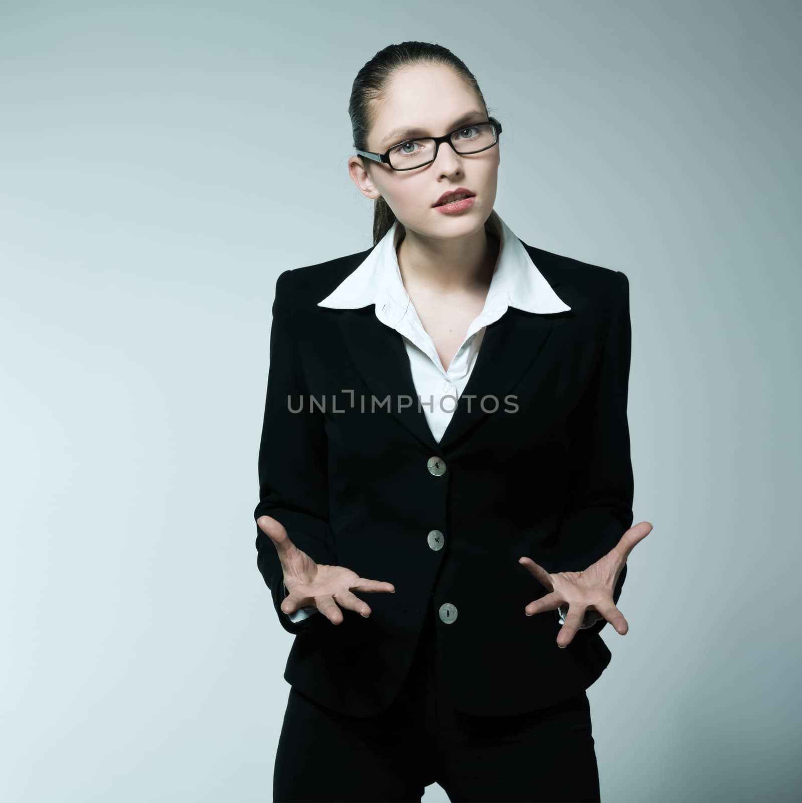 studio shot portrait of one caucasian young angry business woman