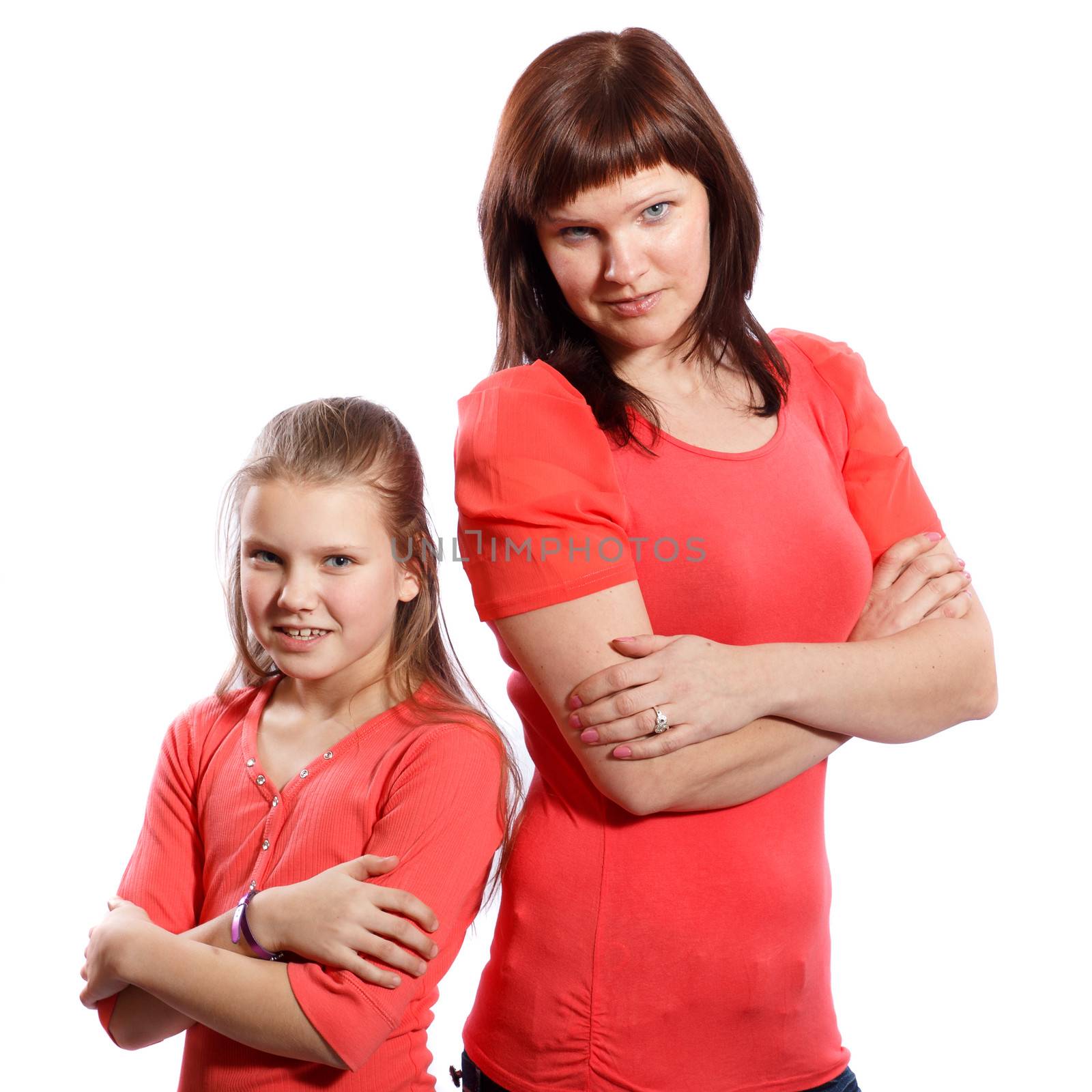 Mother and daughter standing with arms crossed on a white background