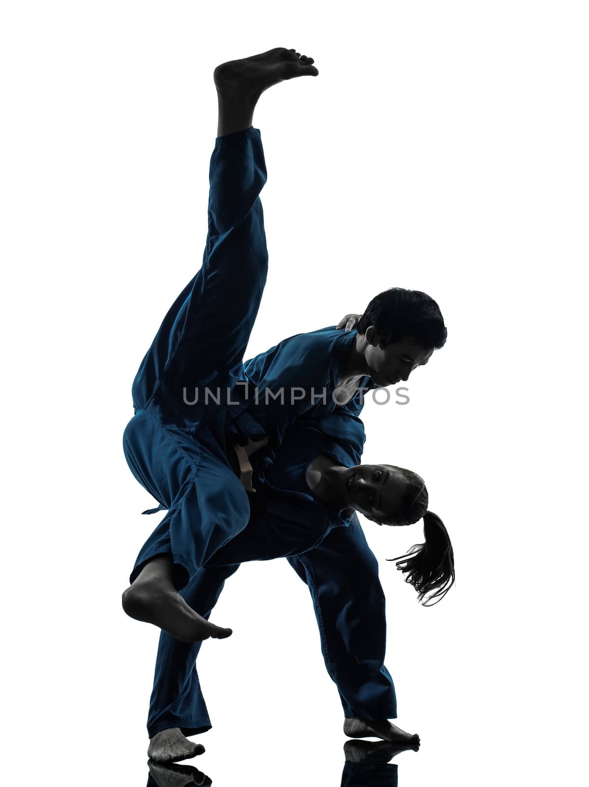 one  man woman couple exercising karate vietvodao martial arts in silhouette studio isolated on white background
