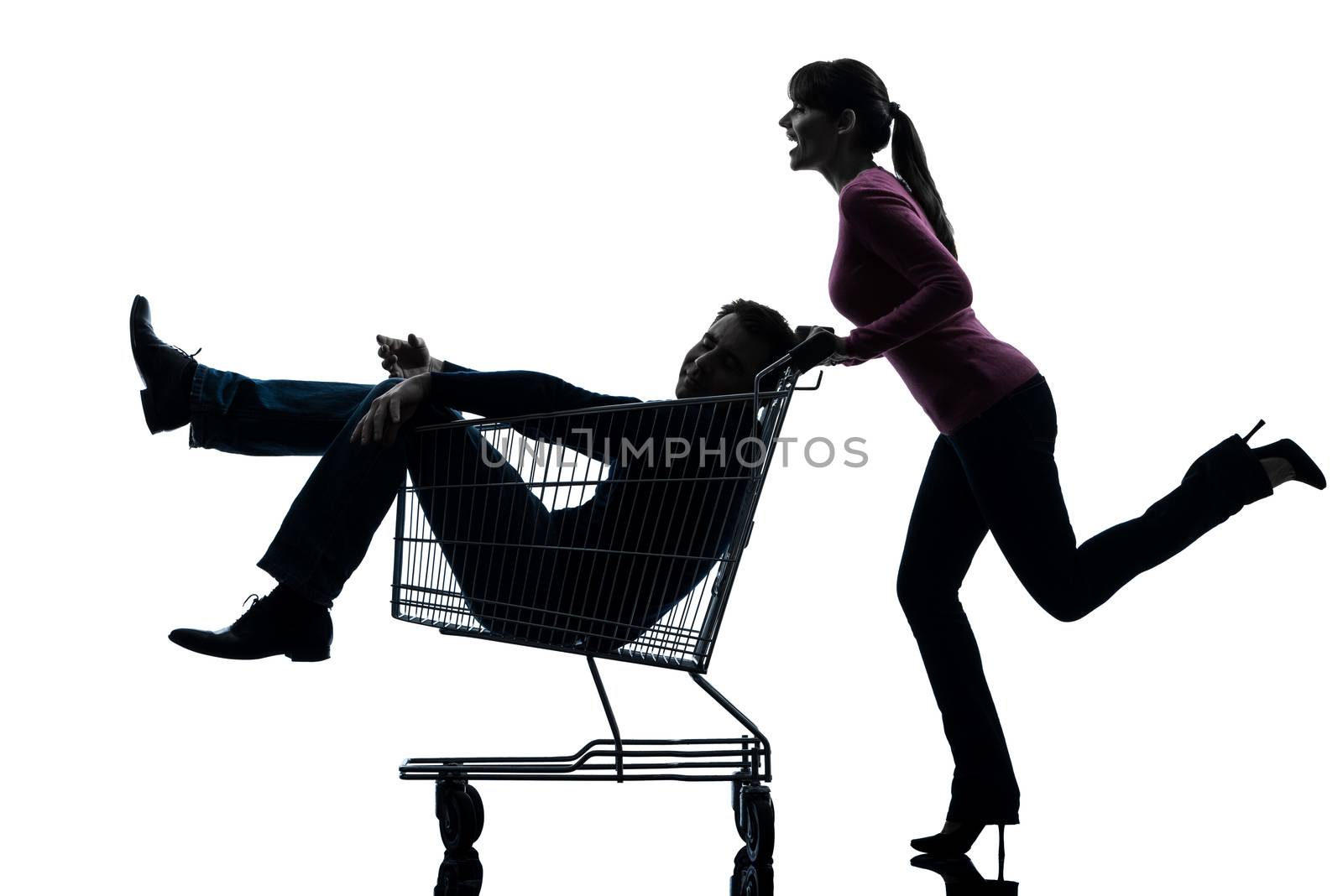 one caucasian couple woman  with man sitting in shopping cart   in silhouette studio isolated on white background