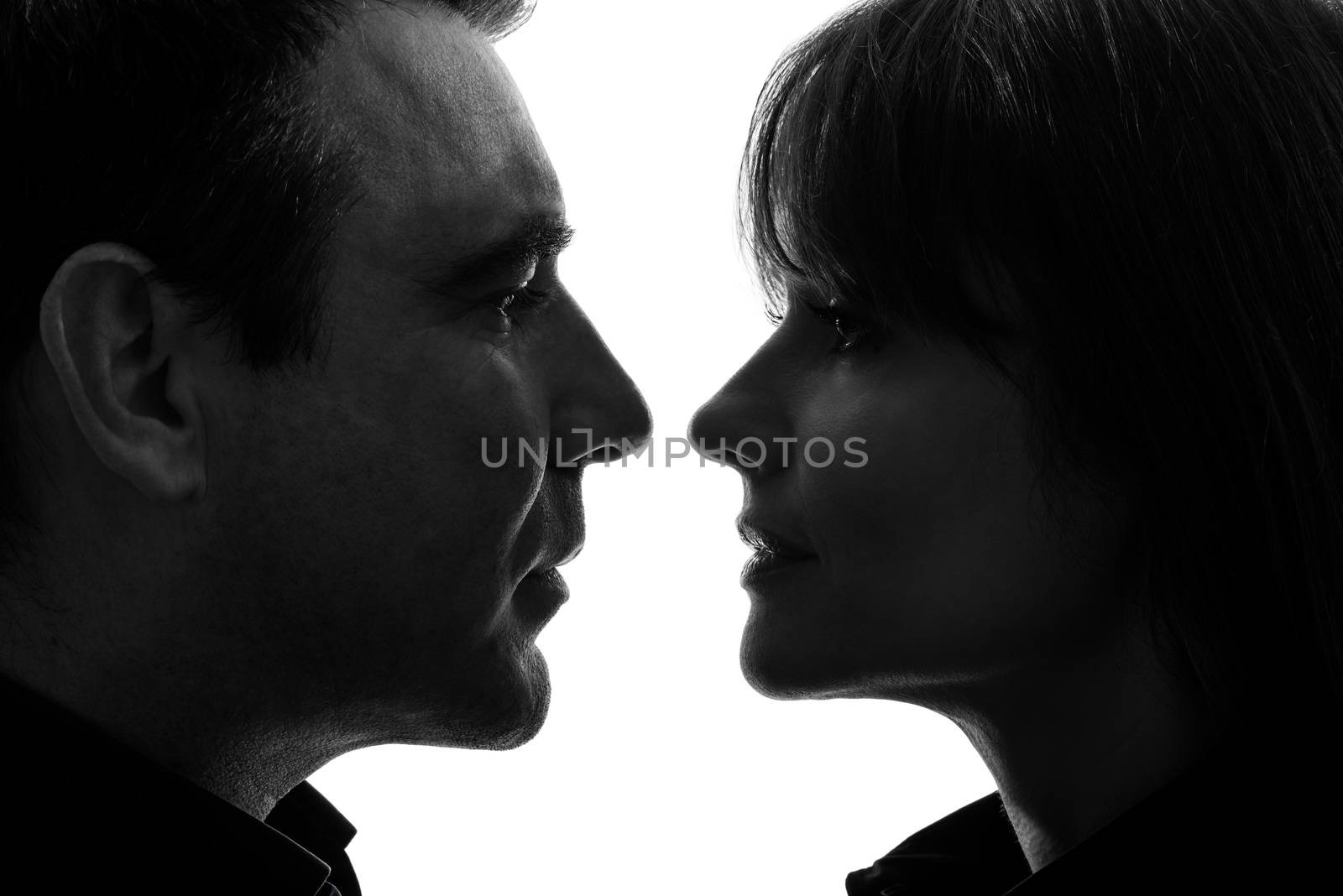 one caucasian couple woman man face to face in silhouette studio isolated on white background