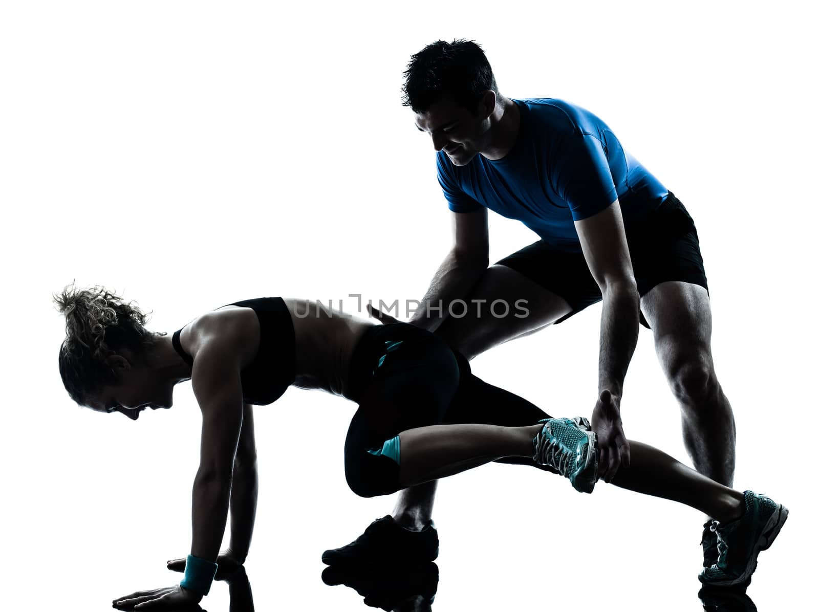 one caucasian couple man woman personal trainer coach exercising legs silhouette studio isolated on white background