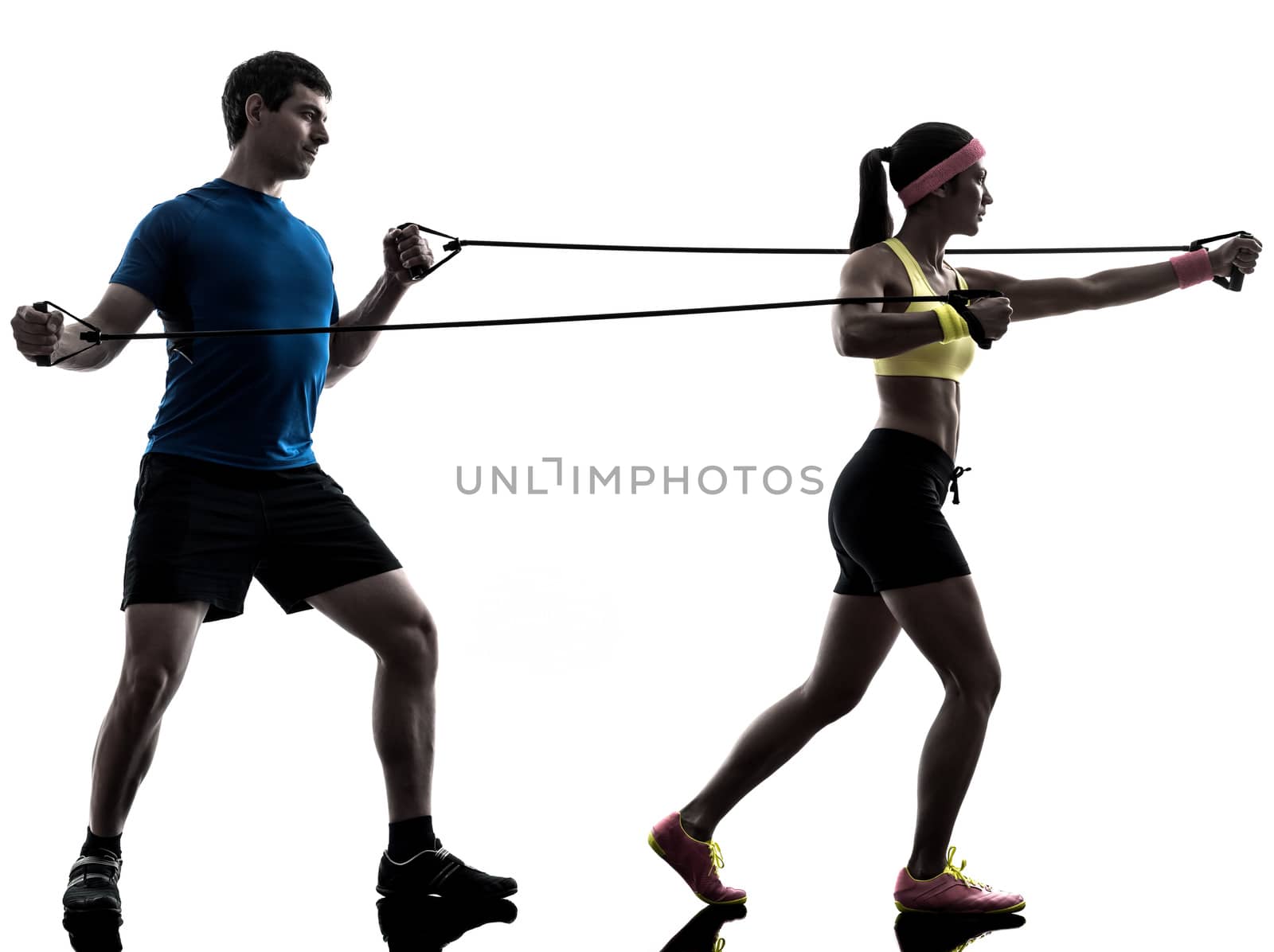 one  woman exercising resistance  rubber band fitness workout with man coach in silhouette  on white background