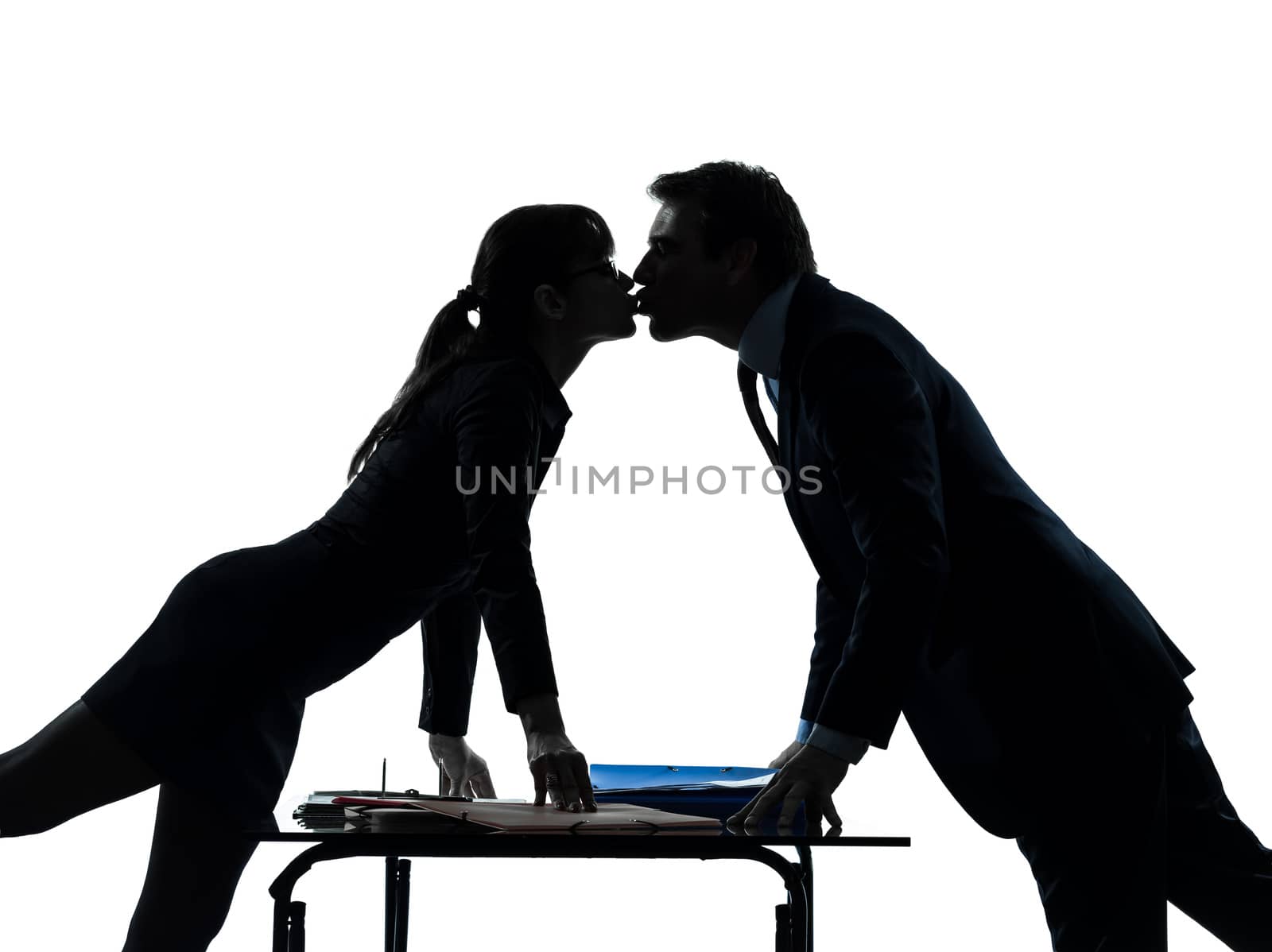 one caucasian business woman man couple lovers kissing   in silhouette studio isolated on white background