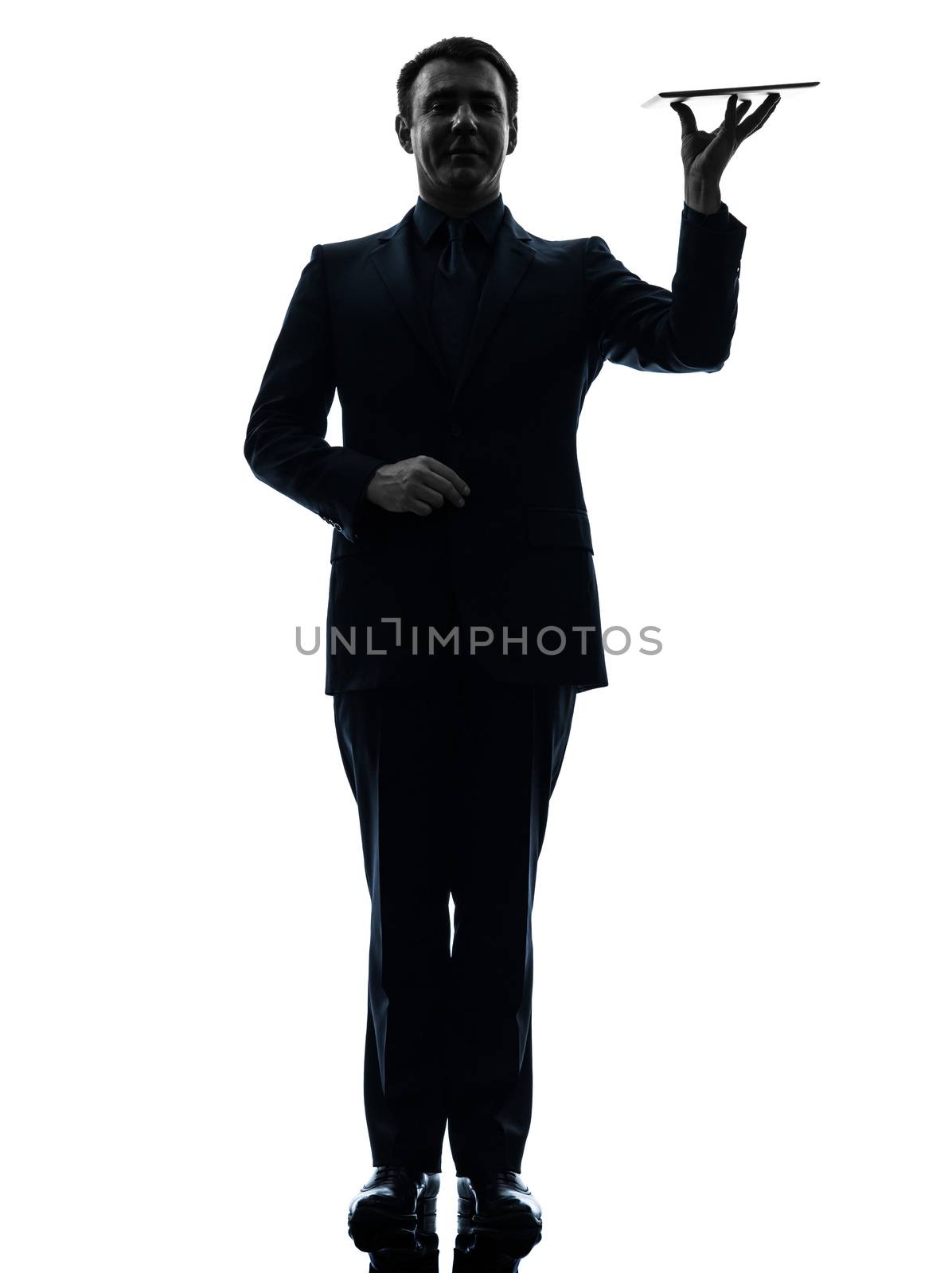 one caucasian business man holding digital tablet   in silhouette on white background
