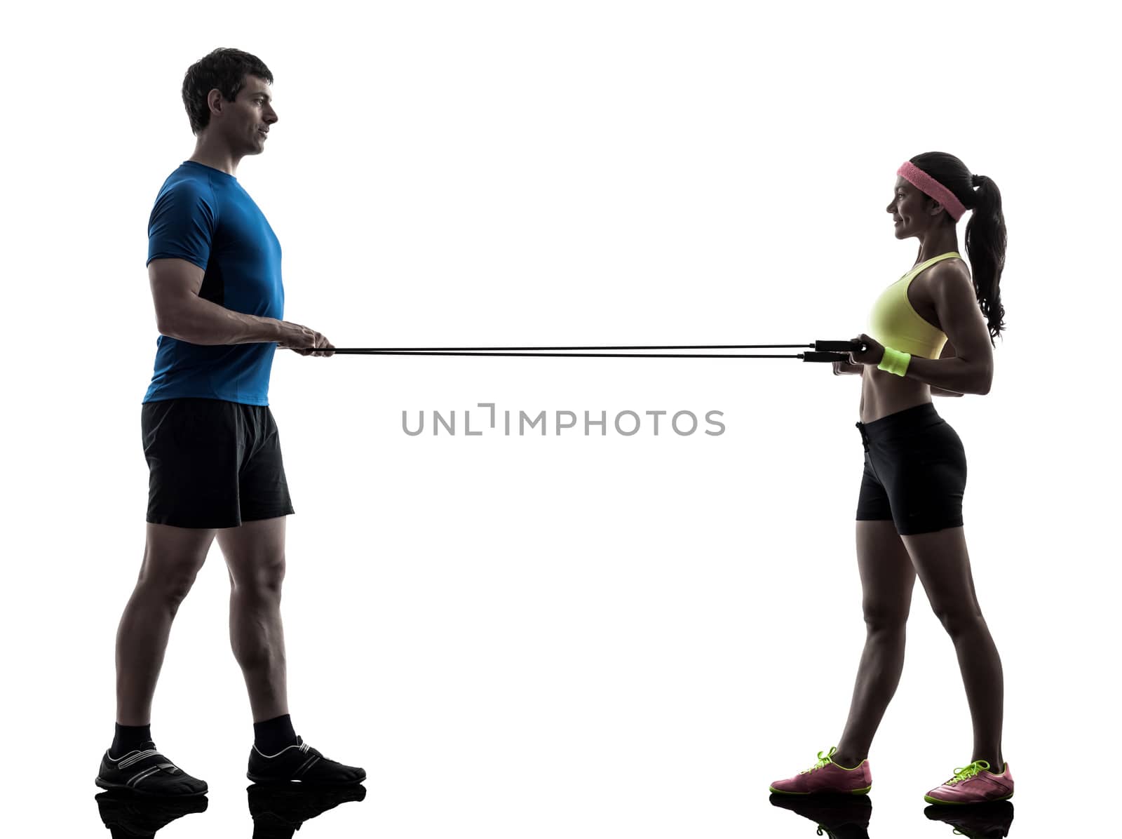 one  woman exercising resistance  rubber band fitness workout with man coach in silhouette  on white background