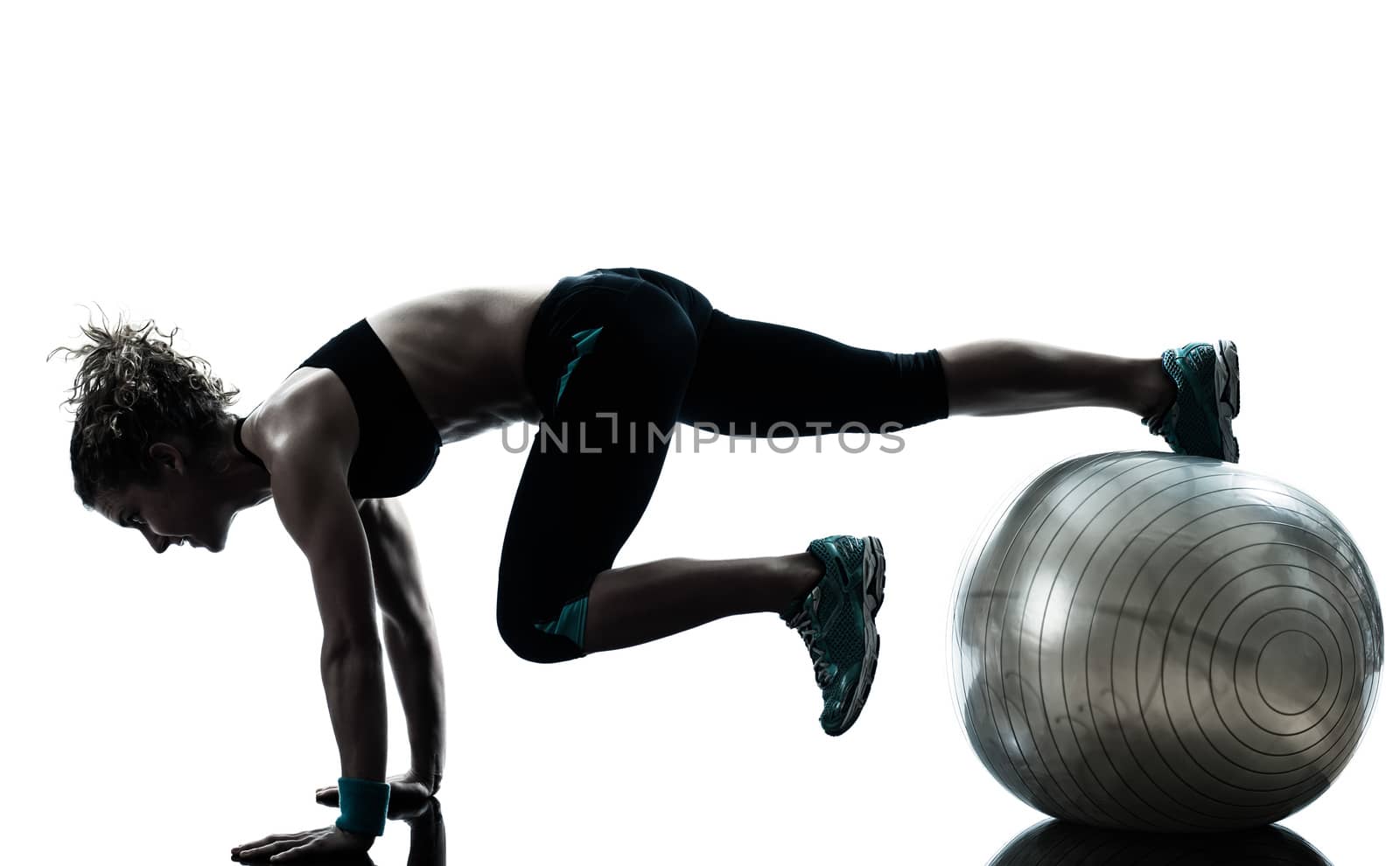 one caucasian woman exercising fitness ball workout posture in silhouette studio isolated on white background