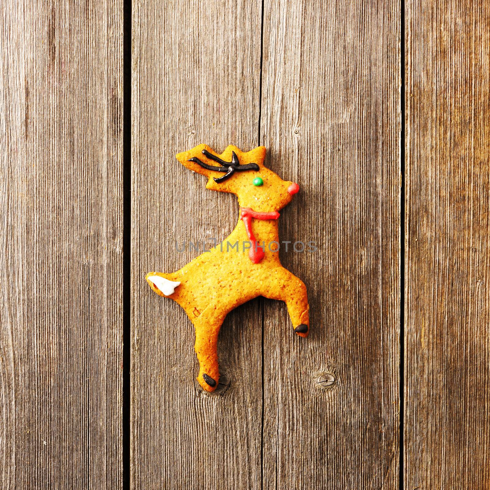 Christmas homemade gingerbread deer over wooden table