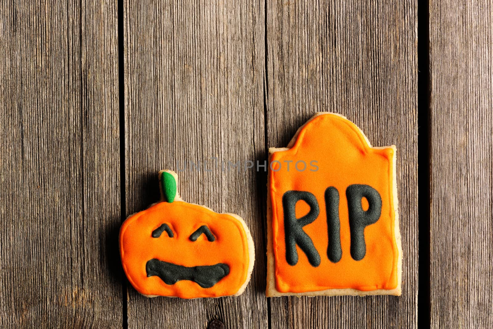 Halloween homemade gingerbread cookies over wooden table