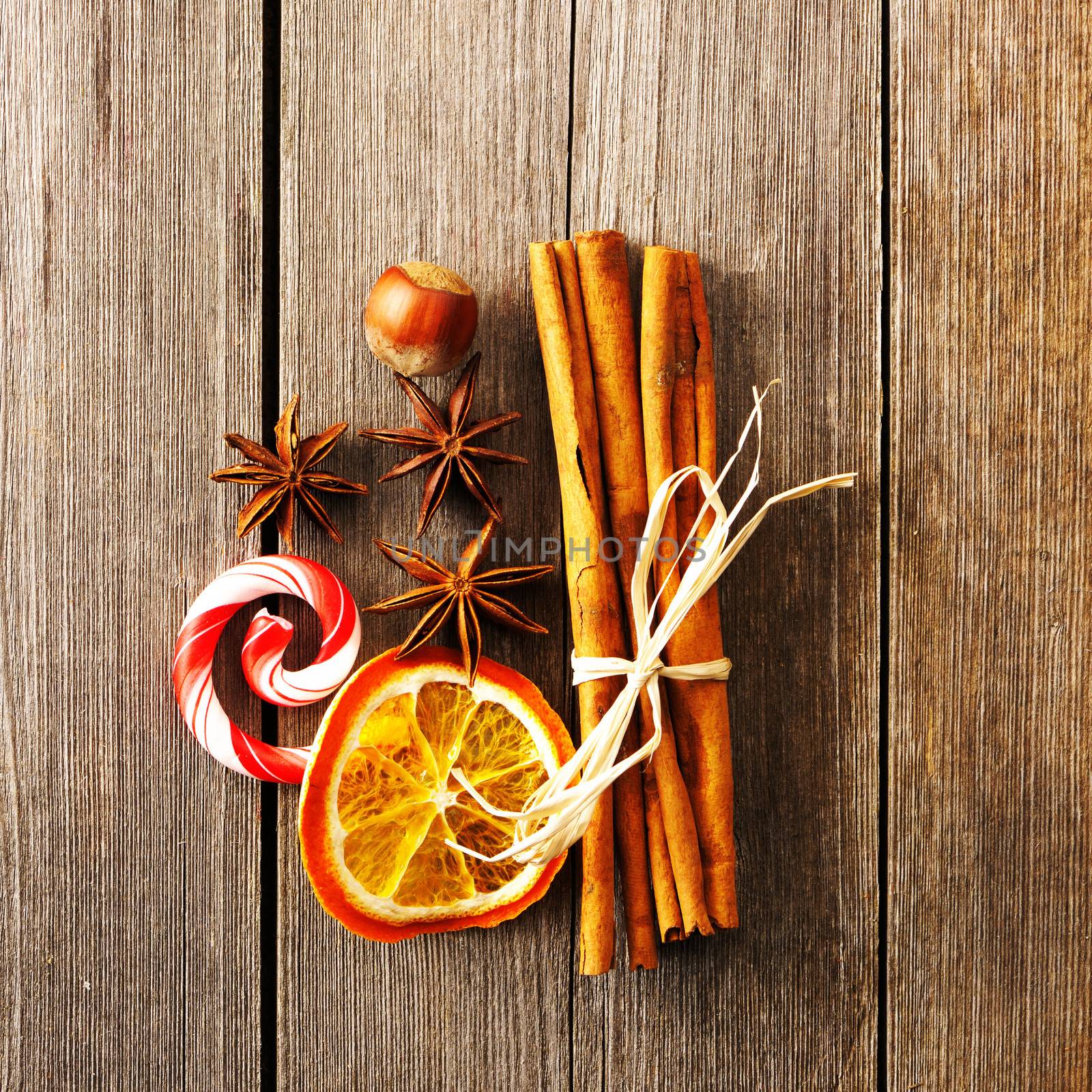 Cinnamon sticks and other spices over wooden table