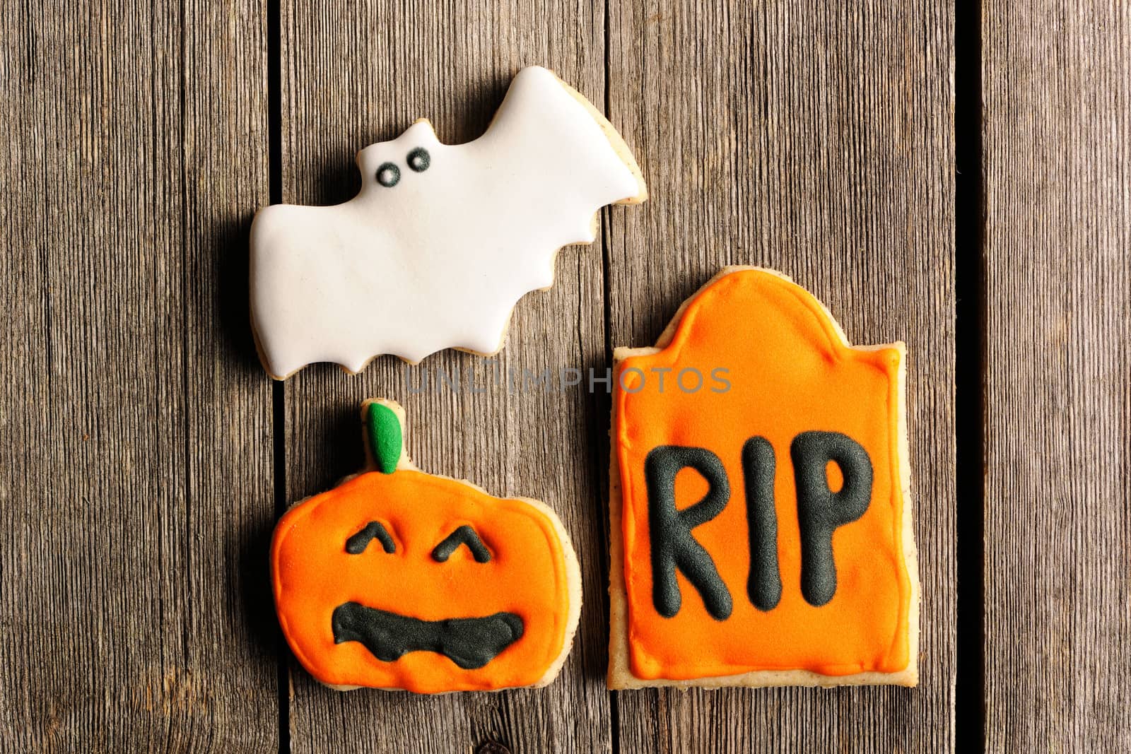 Halloween homemade gingerbread cookies over wooden table