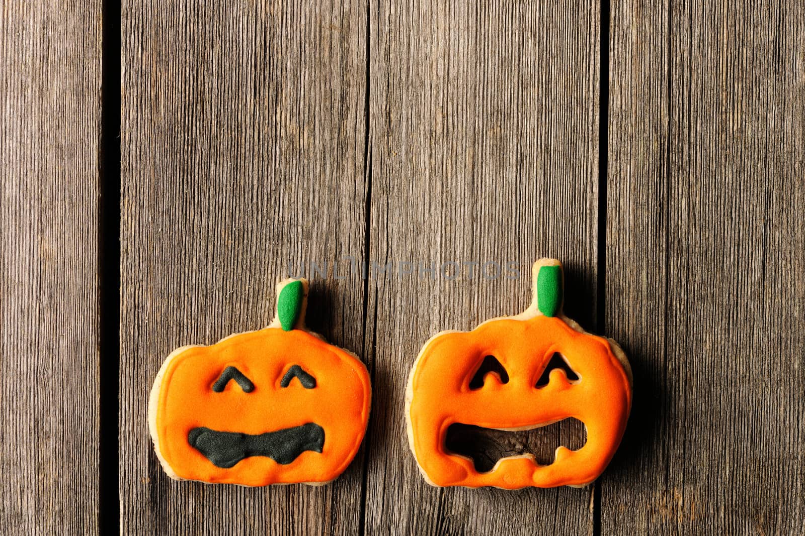 Halloween homemade gingerbread cookies over wooden table