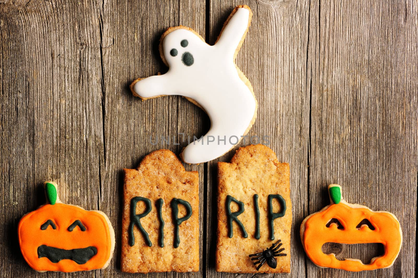 Halloween homemade gingerbread cookies over wooden table