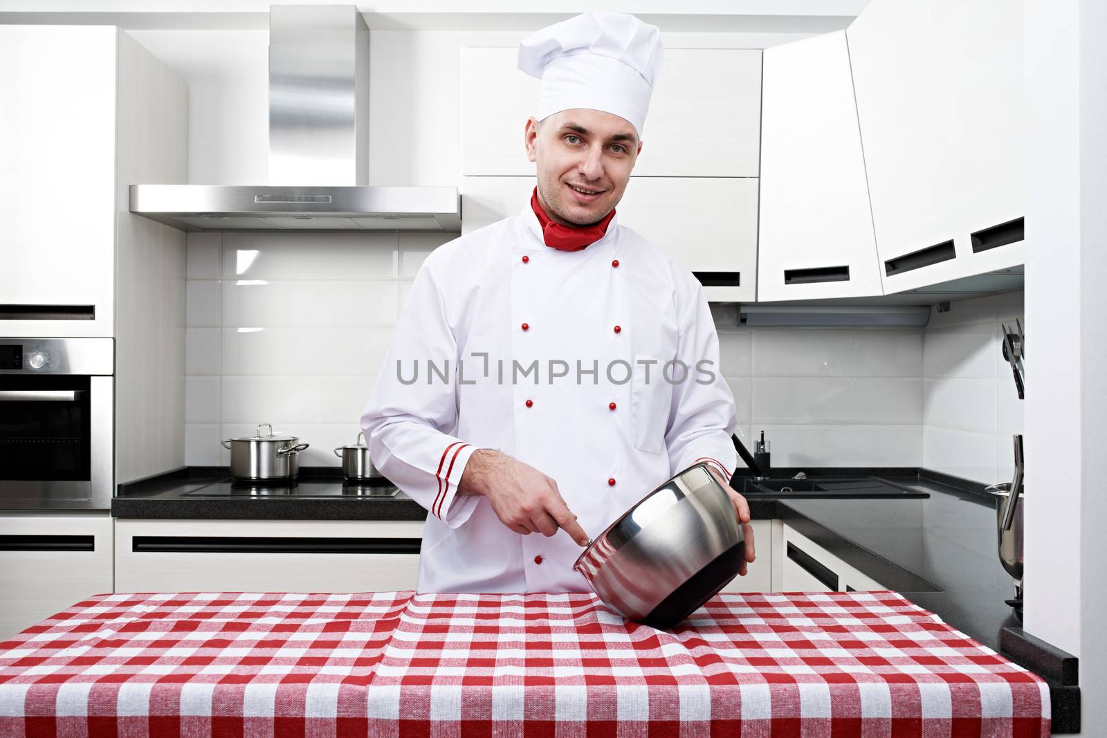 Male chef at kitchen getting ready to cook