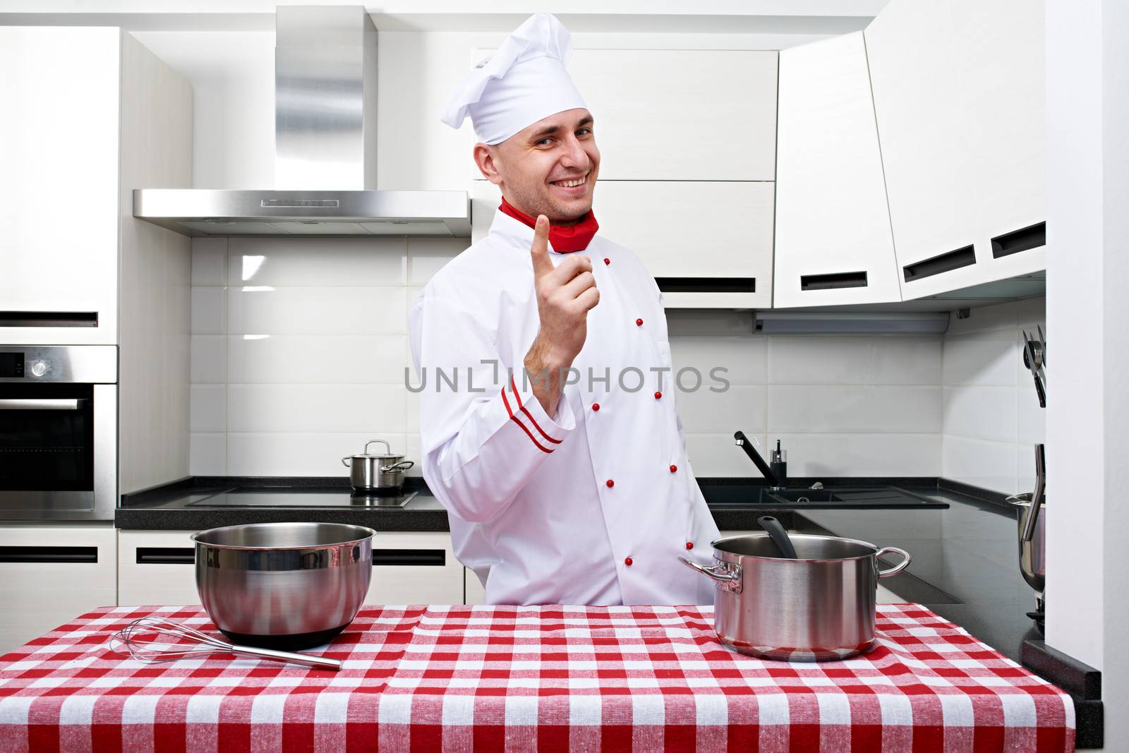 Male chef at kitchen getting ready to cook