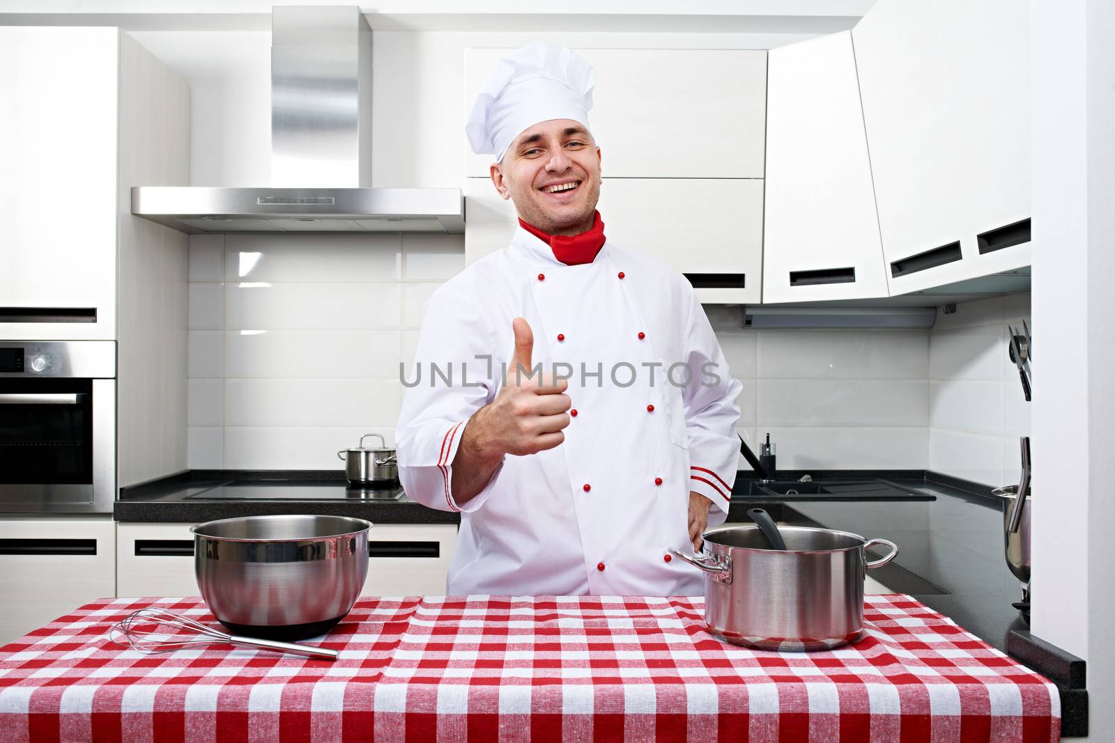 Male chef at kitchen with thumb up