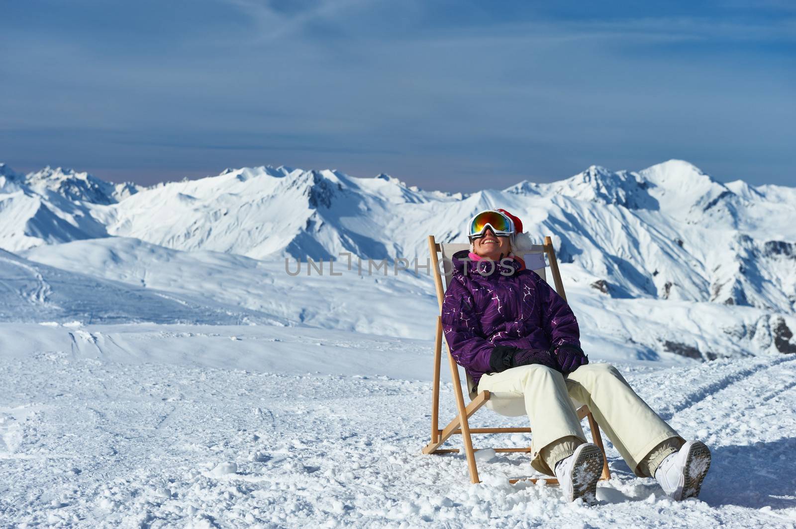 Woman at mountains in Santa hat celebrating christmas, Meribel, Alps, France