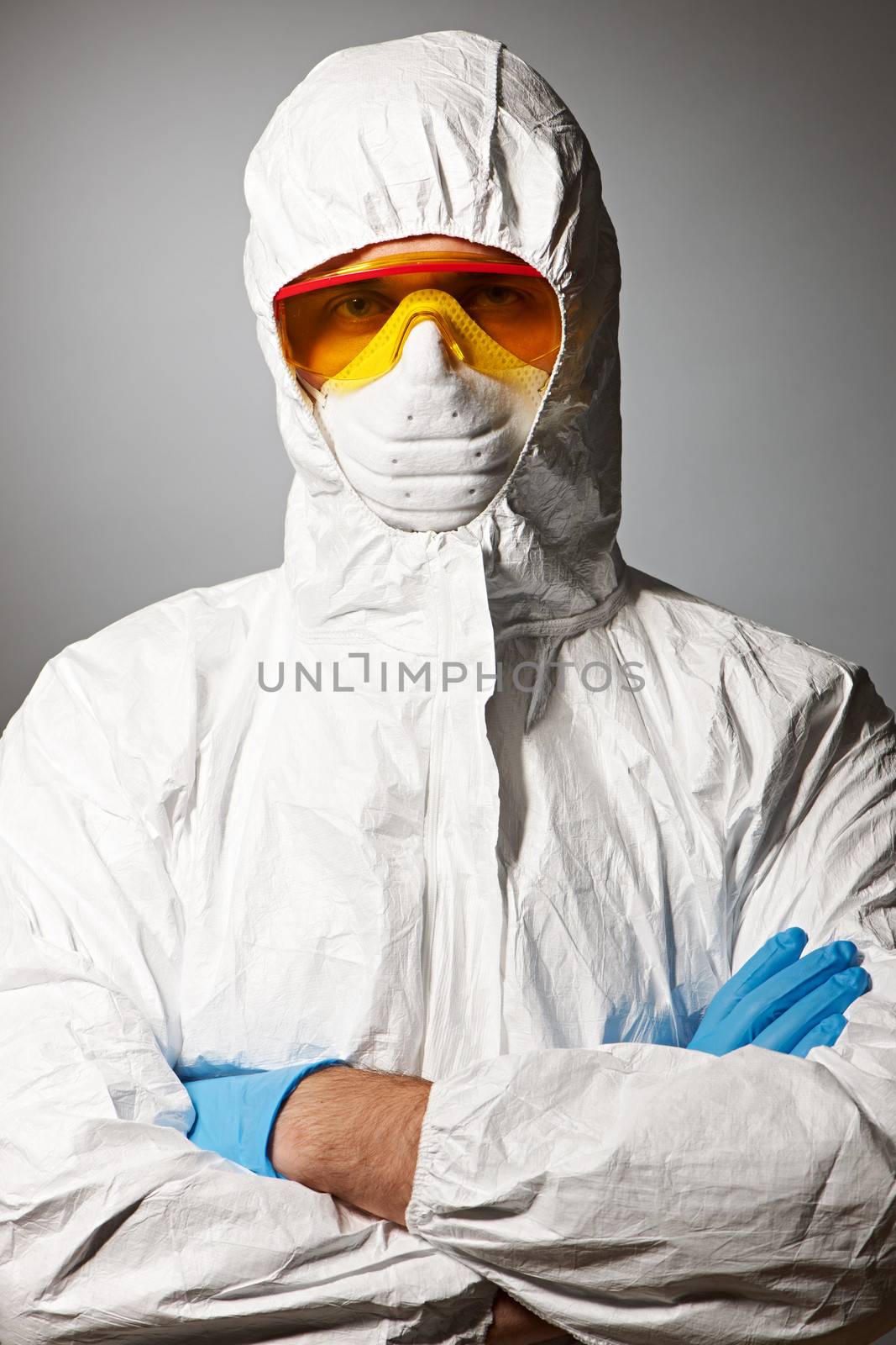 Scientist in protective wear, glasses and respirator 