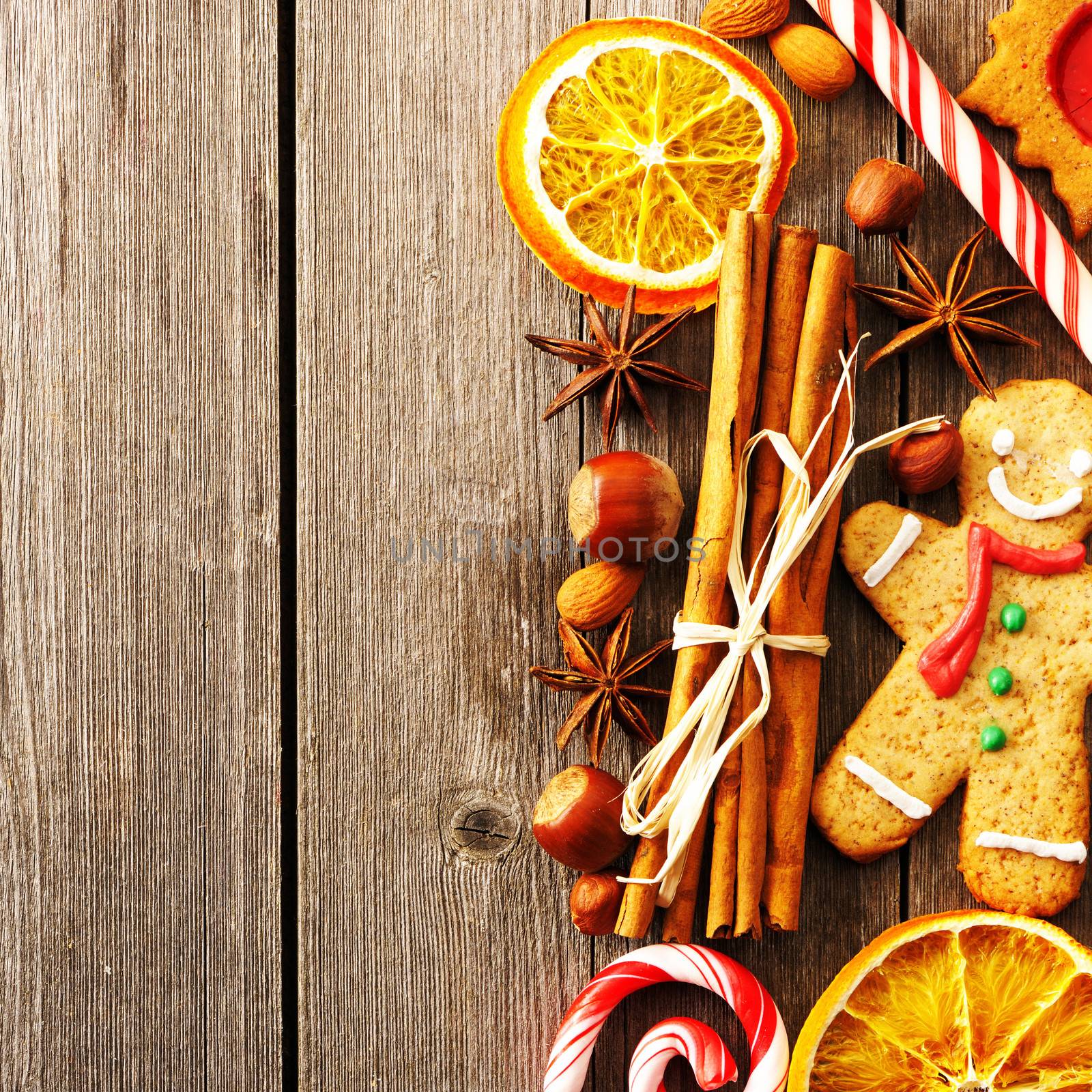 Christmas homemade gingerbread cookie and spices over wooden table