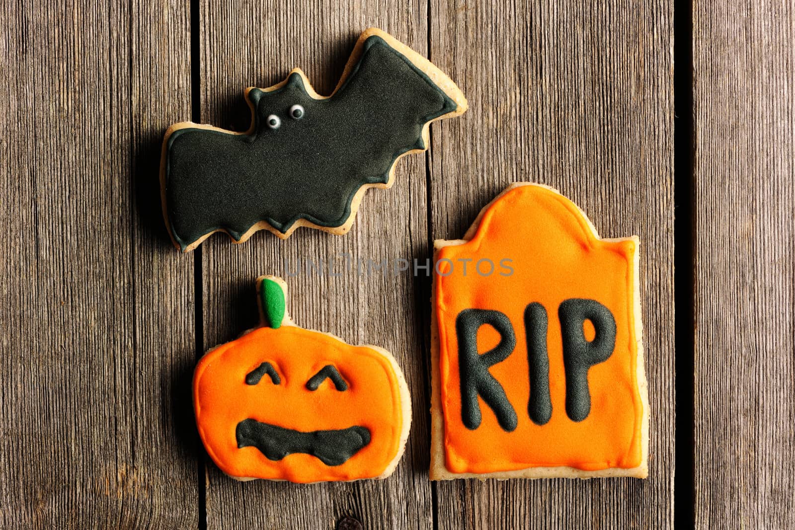 Halloween homemade gingerbread cookies over wooden table