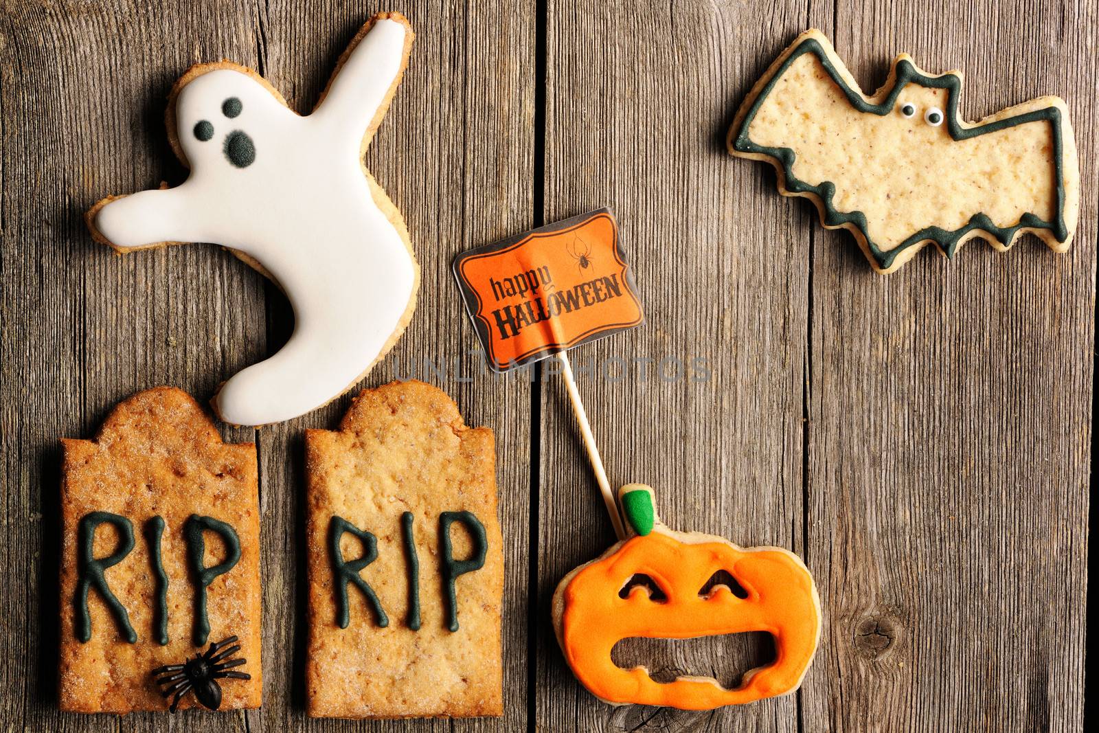 Halloween homemade gingerbread cookies over wooden table