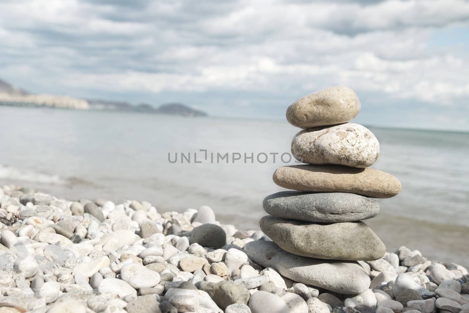 A tall pile of rocks stacked on the beach