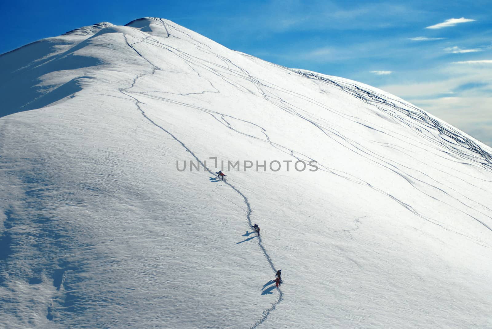 Alpinists climbing a mountain in the sunny day