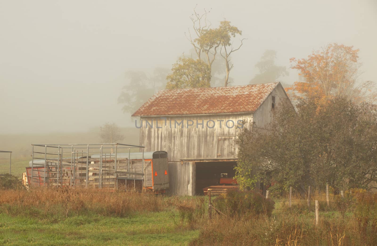 old barn in the countryside on a foggy, overcast day