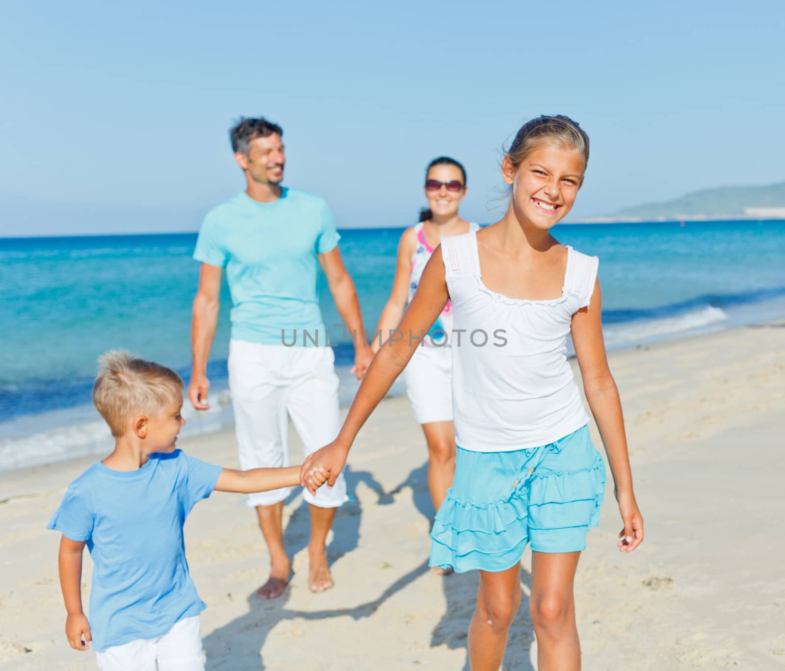 family having fun on beach by maxoliki