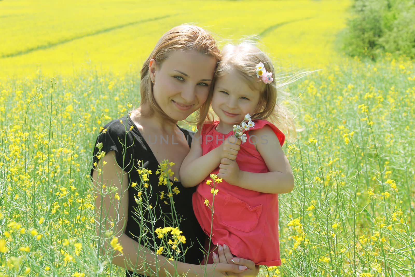 Mother and daughter in rapeseed field by Angel_a