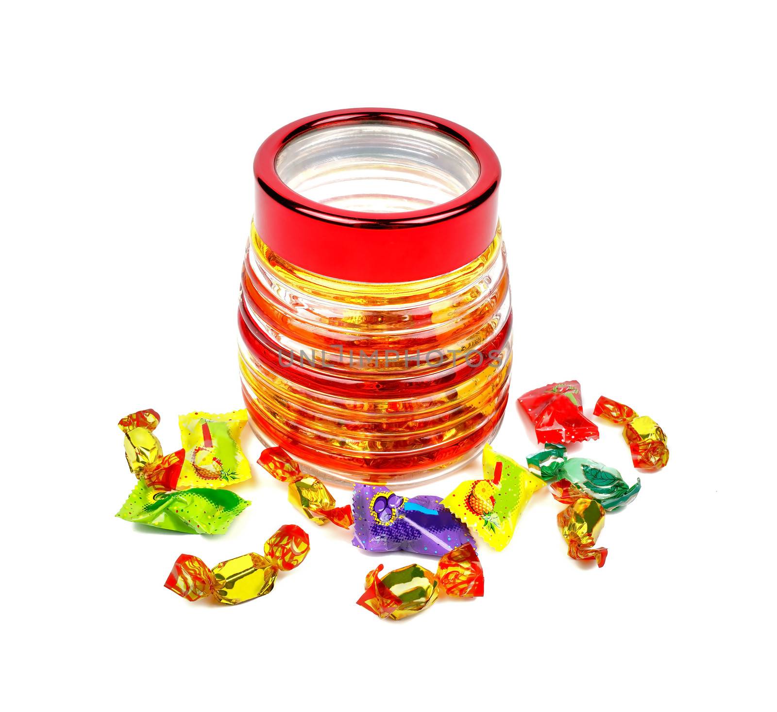 Sweets in the form of a barrel with scattered near her chocolates on a white background