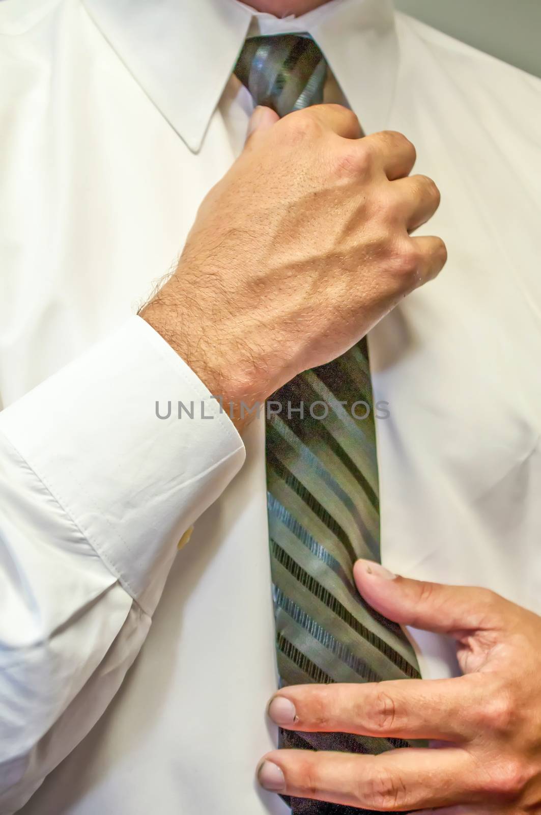 man fixing a tie with hands by digidreamgrafix