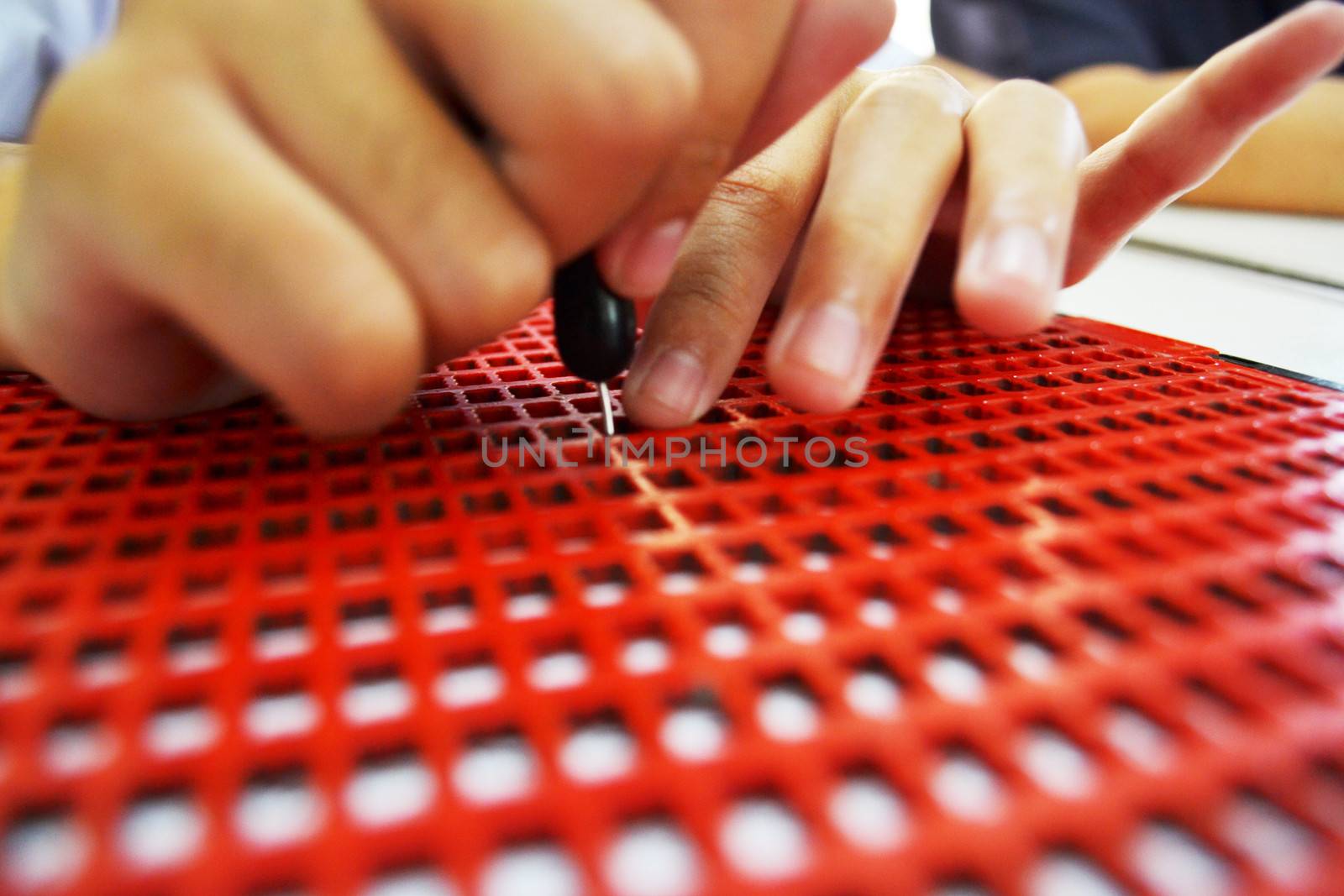 Writing braille. For blind children.