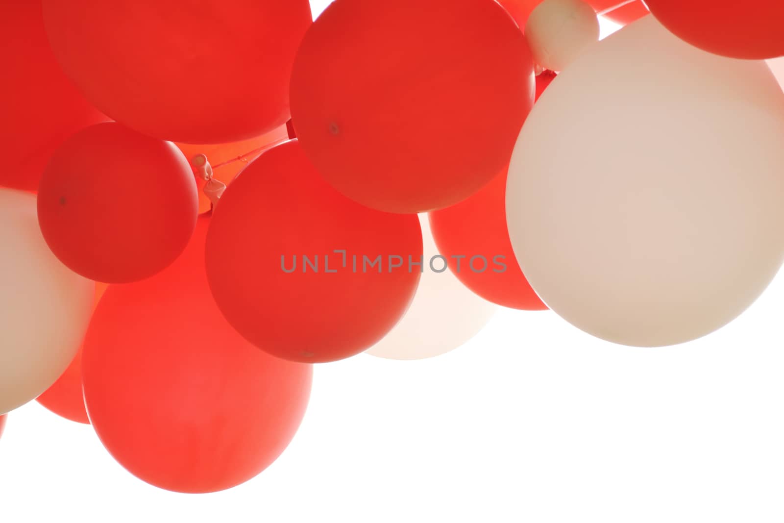 Red balloons hanging on white.