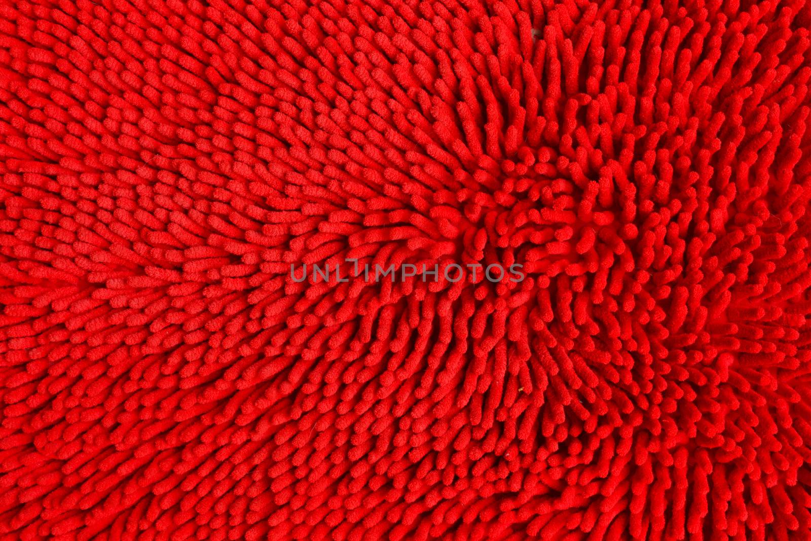 Doormat red in front of the door.