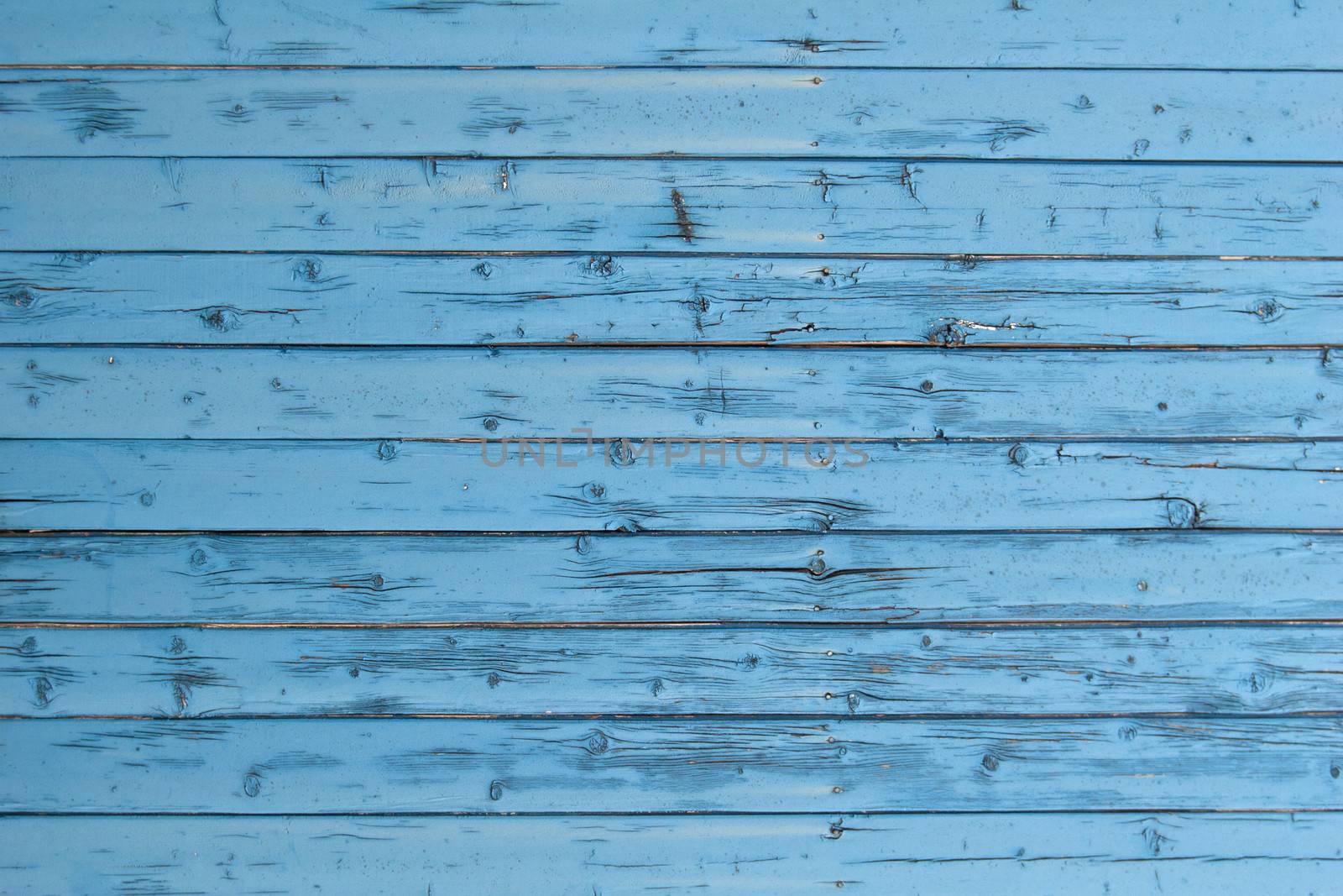 part of weathered blue boards of fence