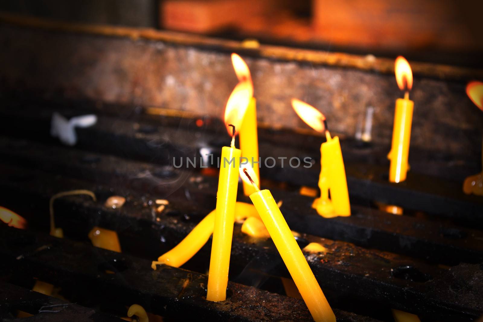 Yellow candles burning on the altar.