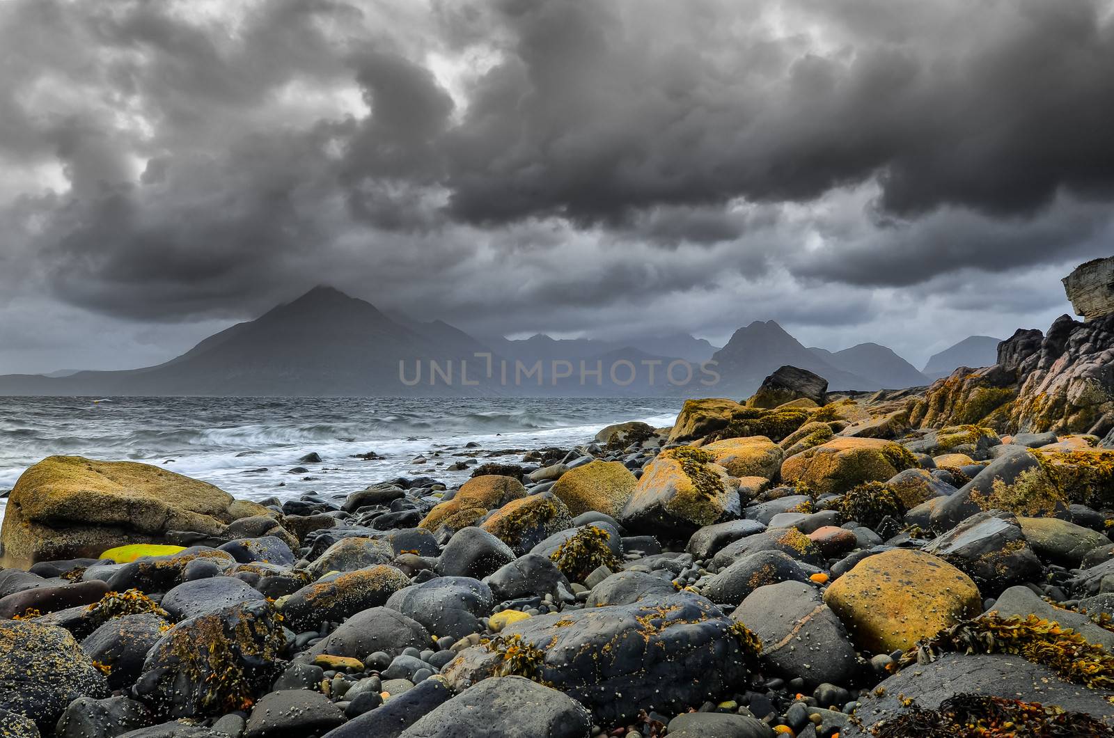 Landscape coastline view of rocks and Cullin hills, Scotland, United Kingdom