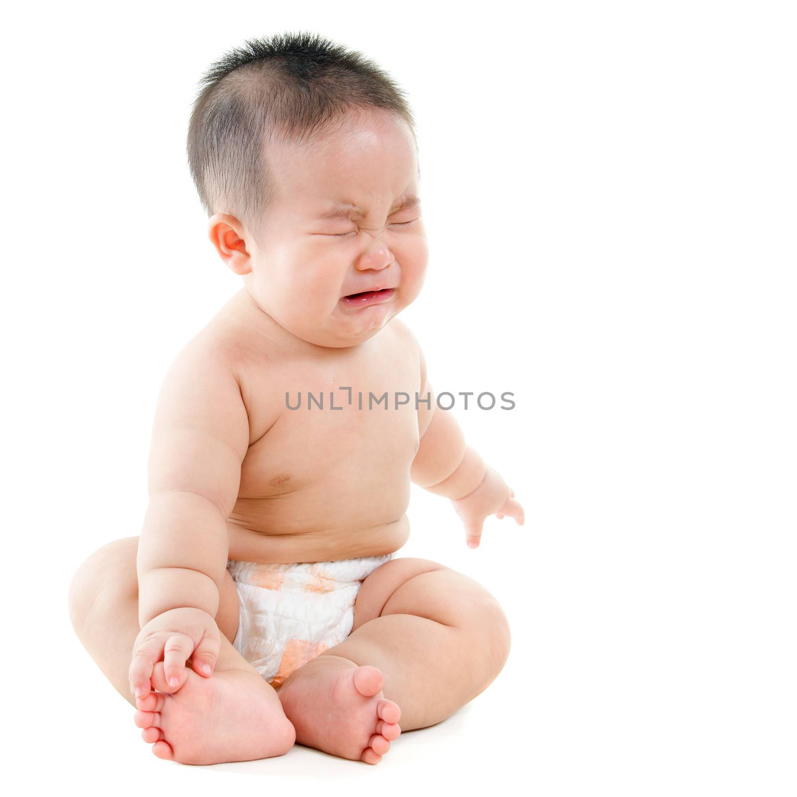 Full body upset Asian baby boy crying, sitting isolated on white background