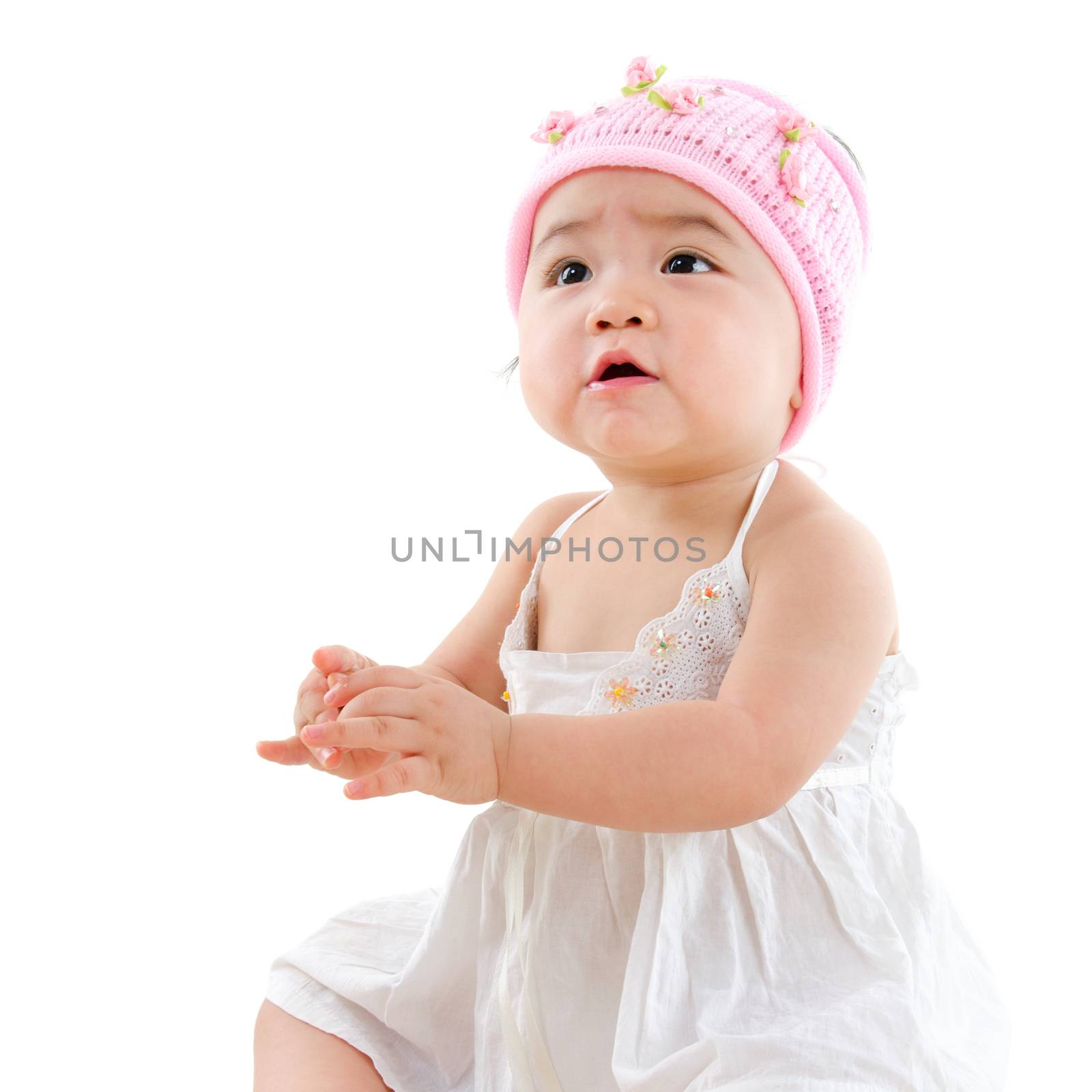 Portrait of cute Asian baby girl looking up,  isolated on white background