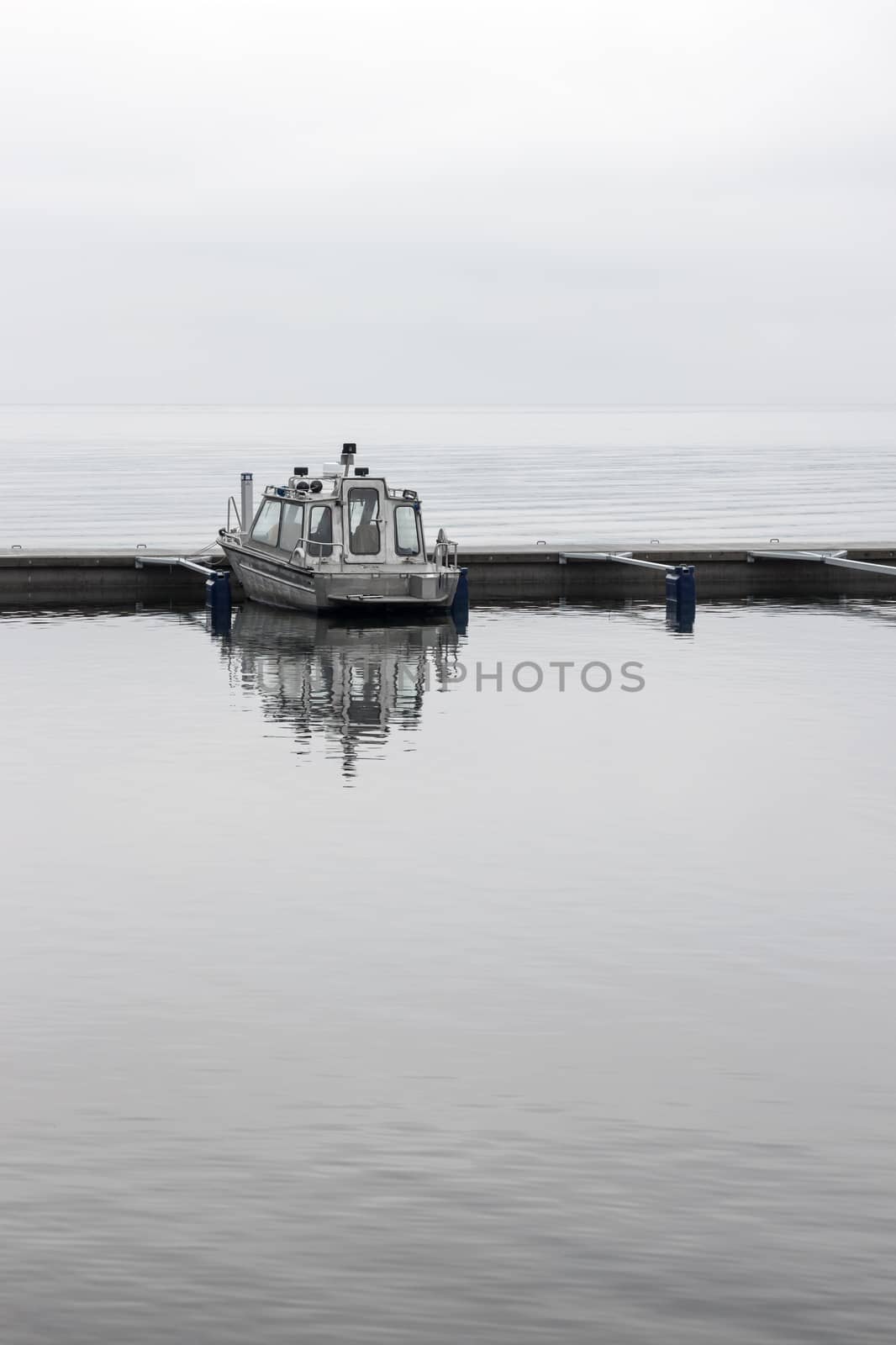 Solitary boat in a harbor, on a calm day.