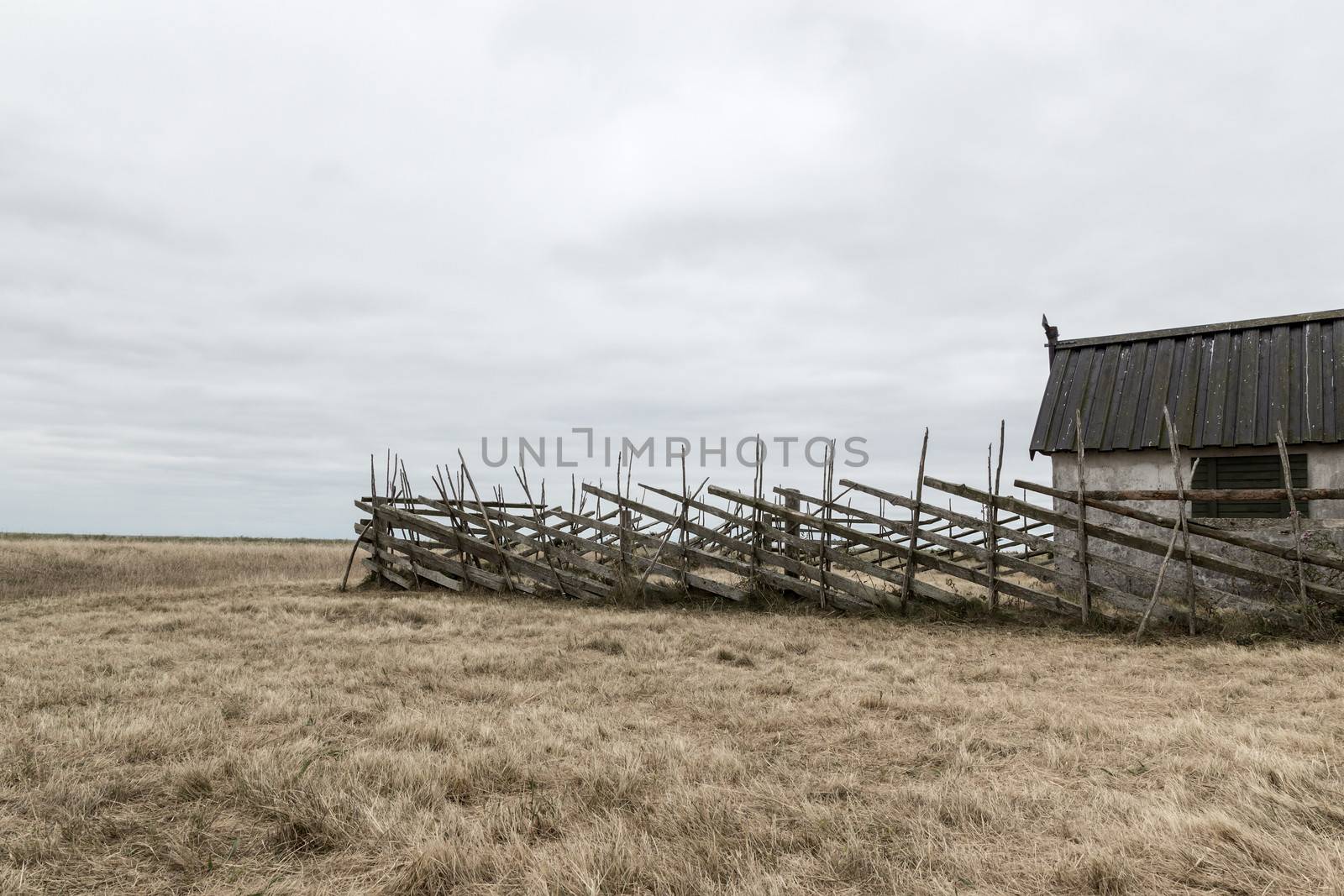Old barn in the gloomy field. Island of Gotland, Sweden.