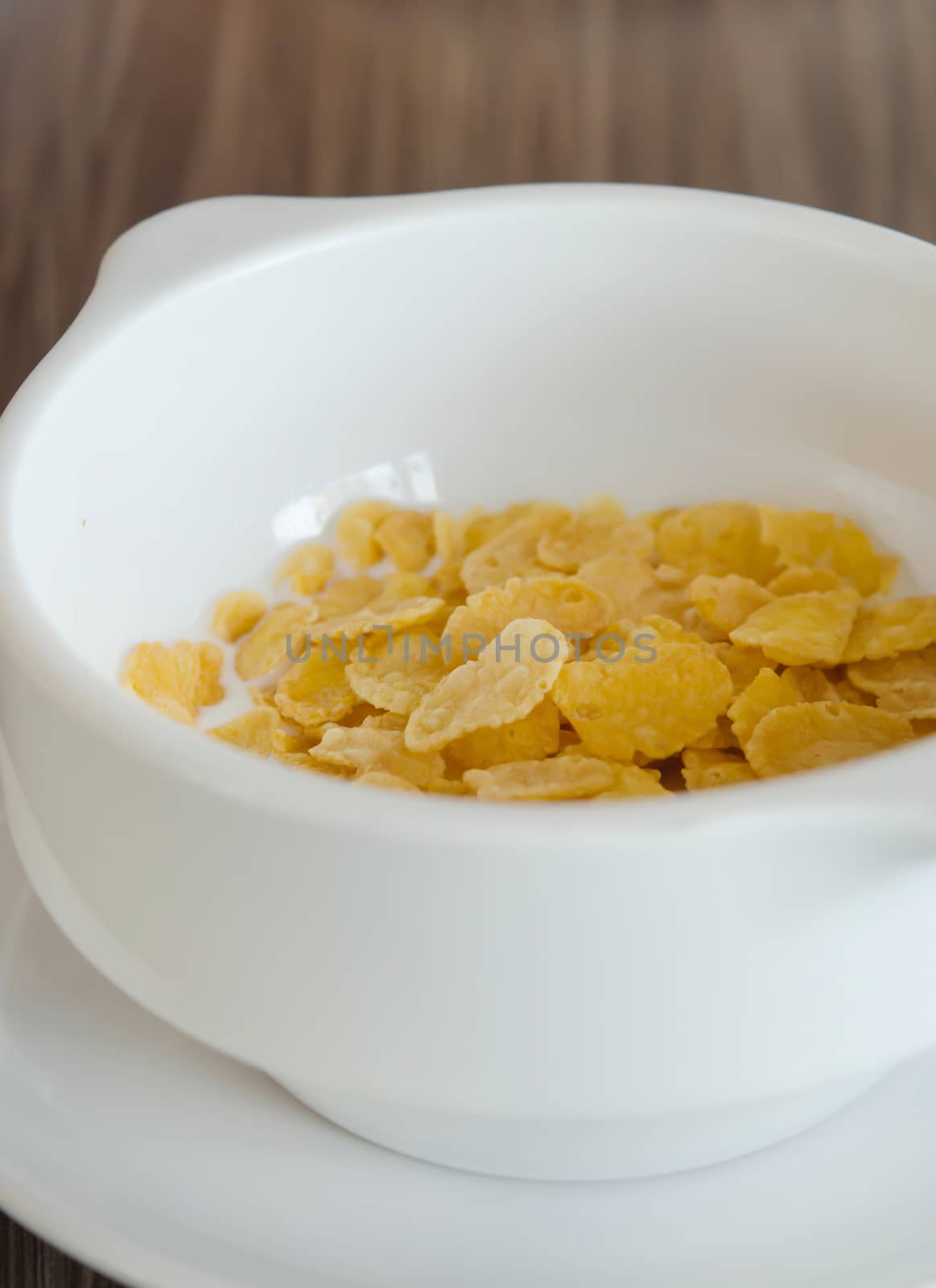 close up of  cereal with fresh  milk in white bowl