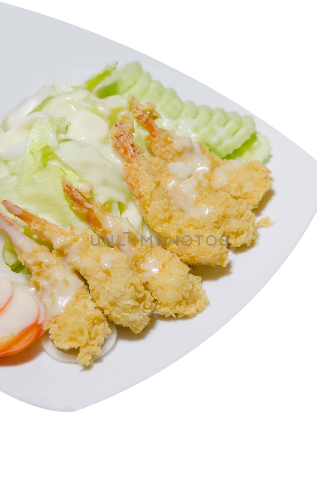 deep fried shrimp and  fresh vegetable salad on dish over white background