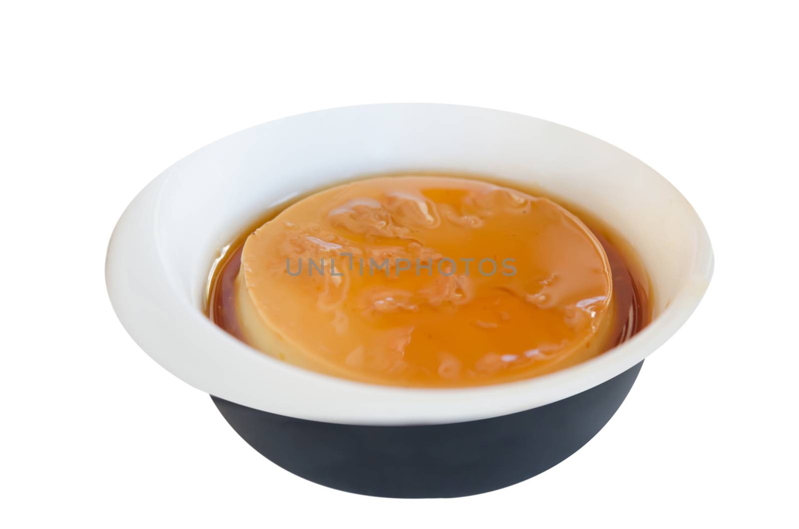 Caramel custard in bowl over white background