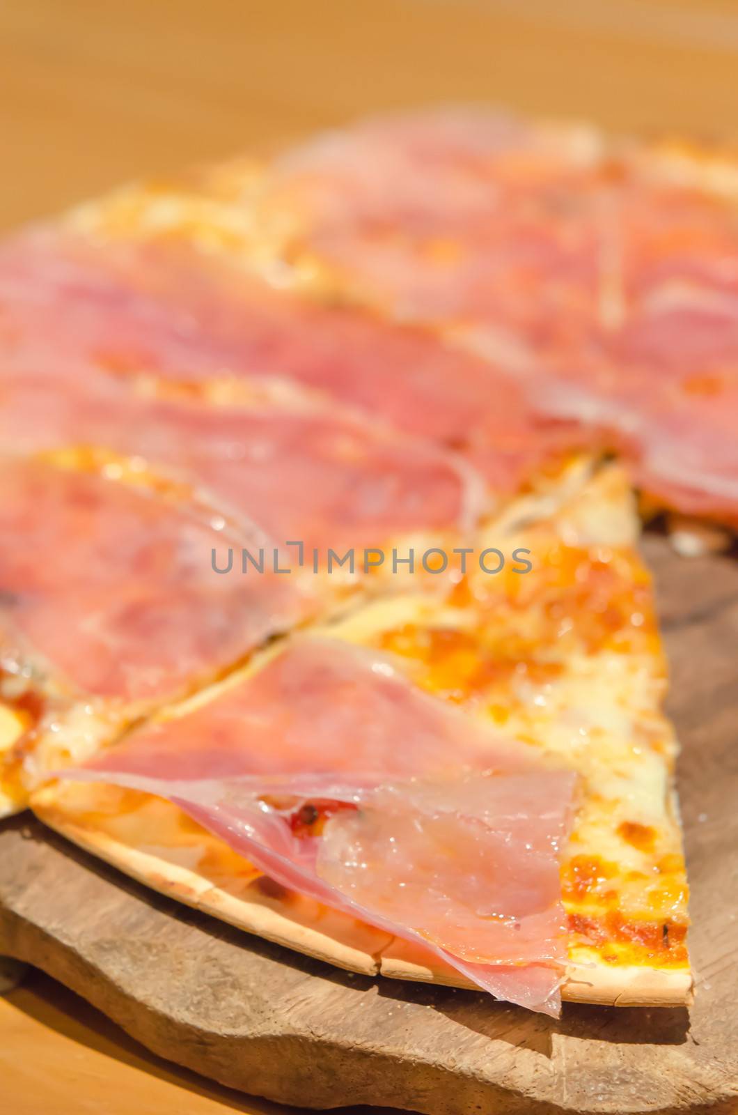 close up fast food ,  homemade crispy  pizza with ham over wooden plate